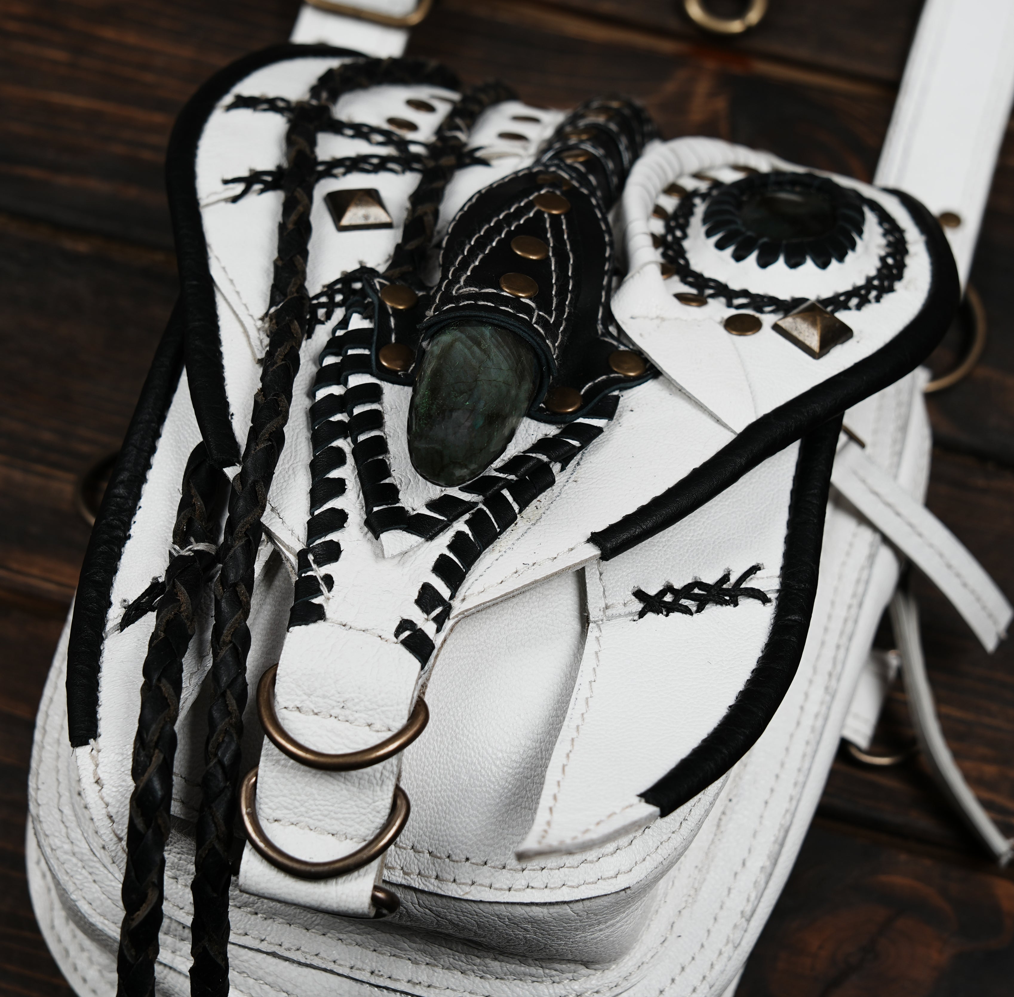 White and black leather harness holster with decorative stitching