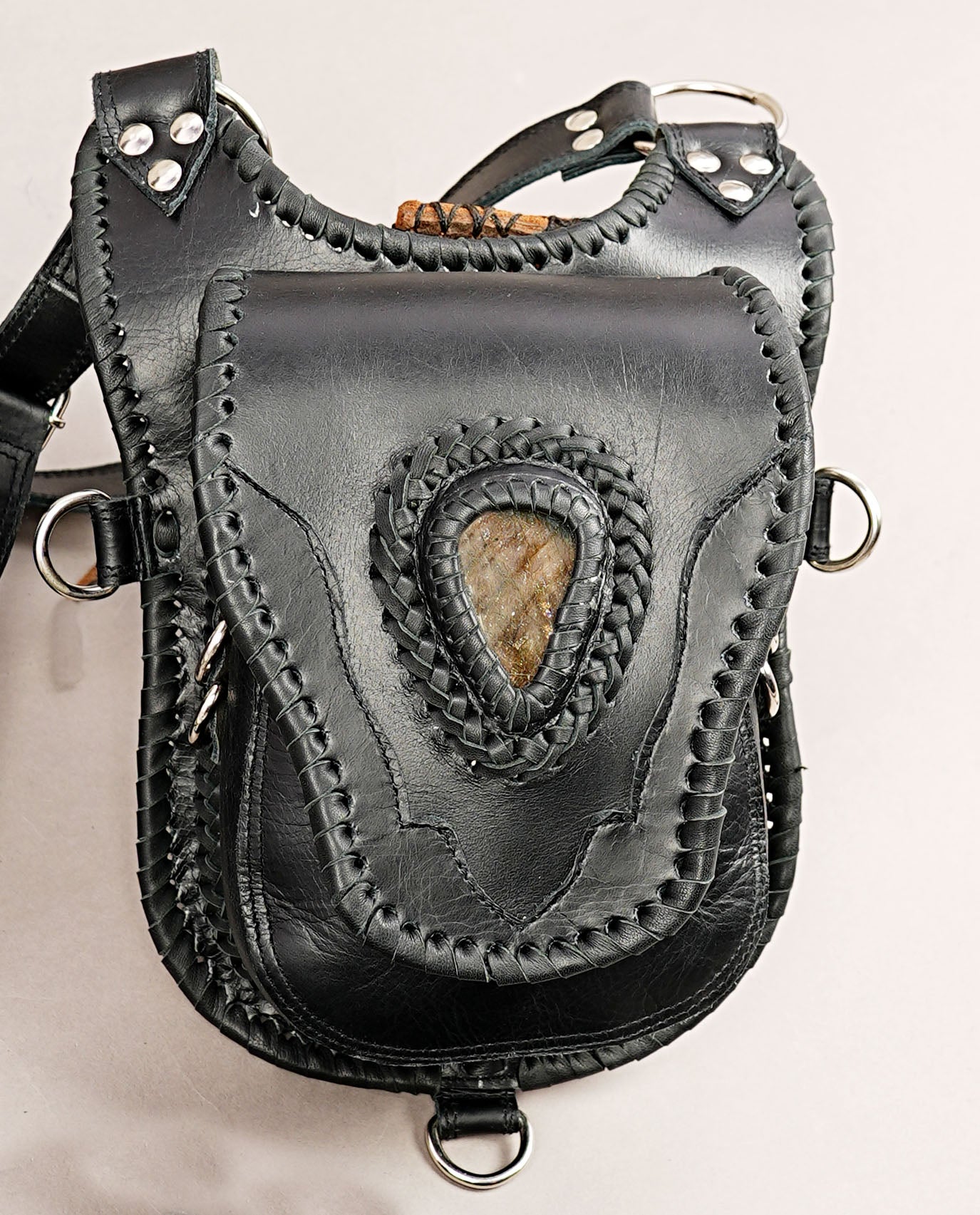 Gothic-inspired leather holster with stone detailing