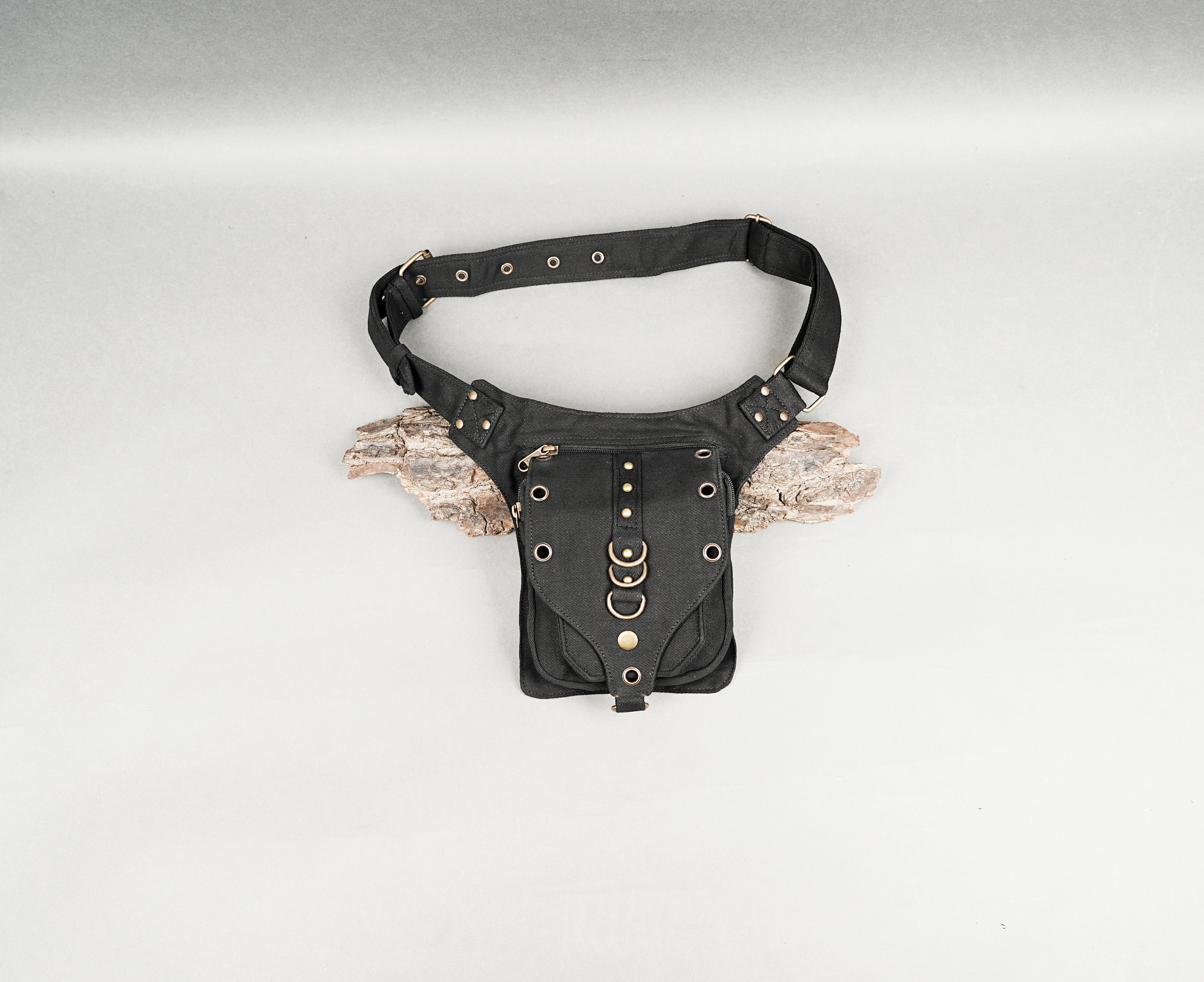 Black canvas waist bag with adjustable strap and brass hardware