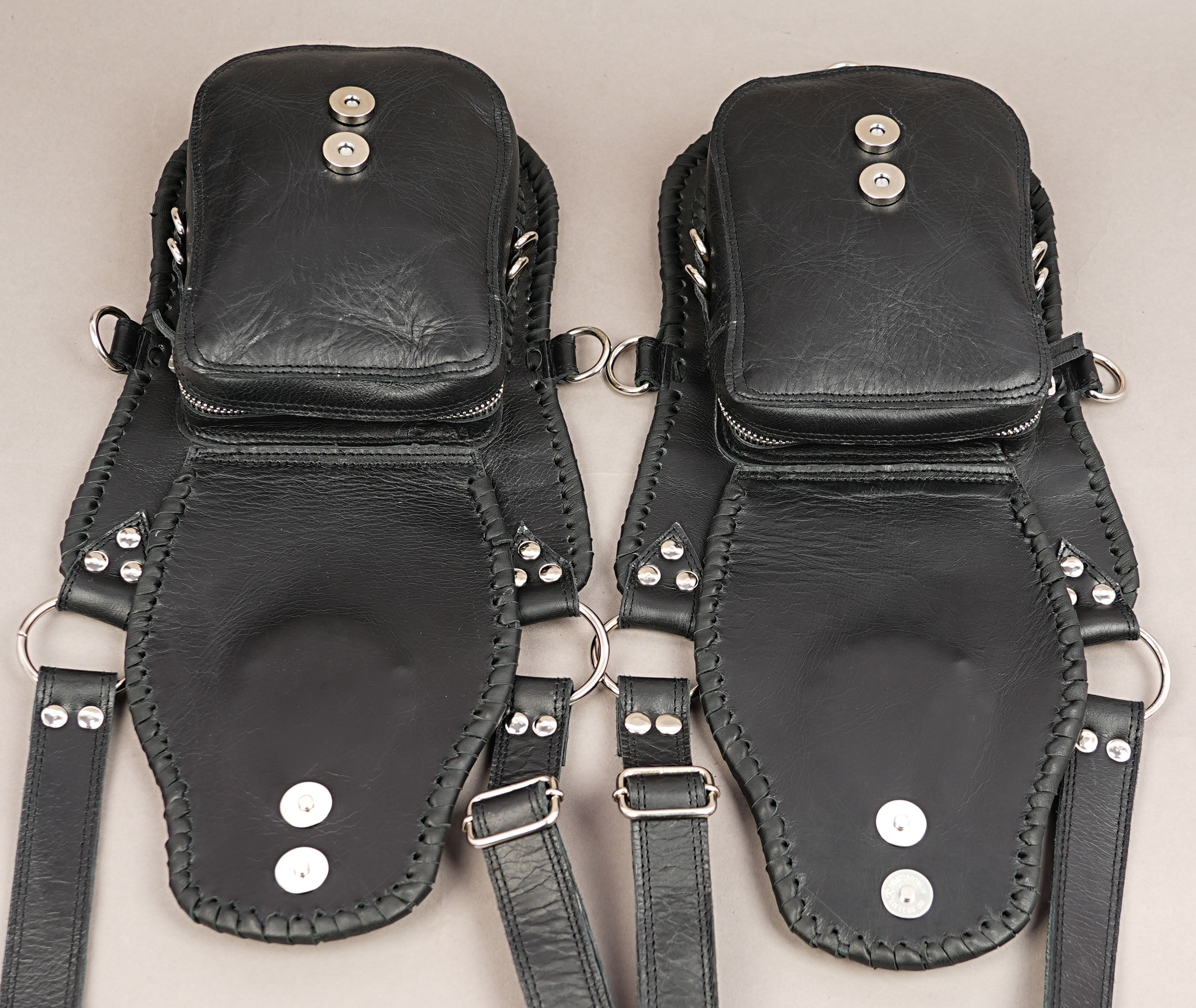 Dual pocket leather shoulder holster with braided edging