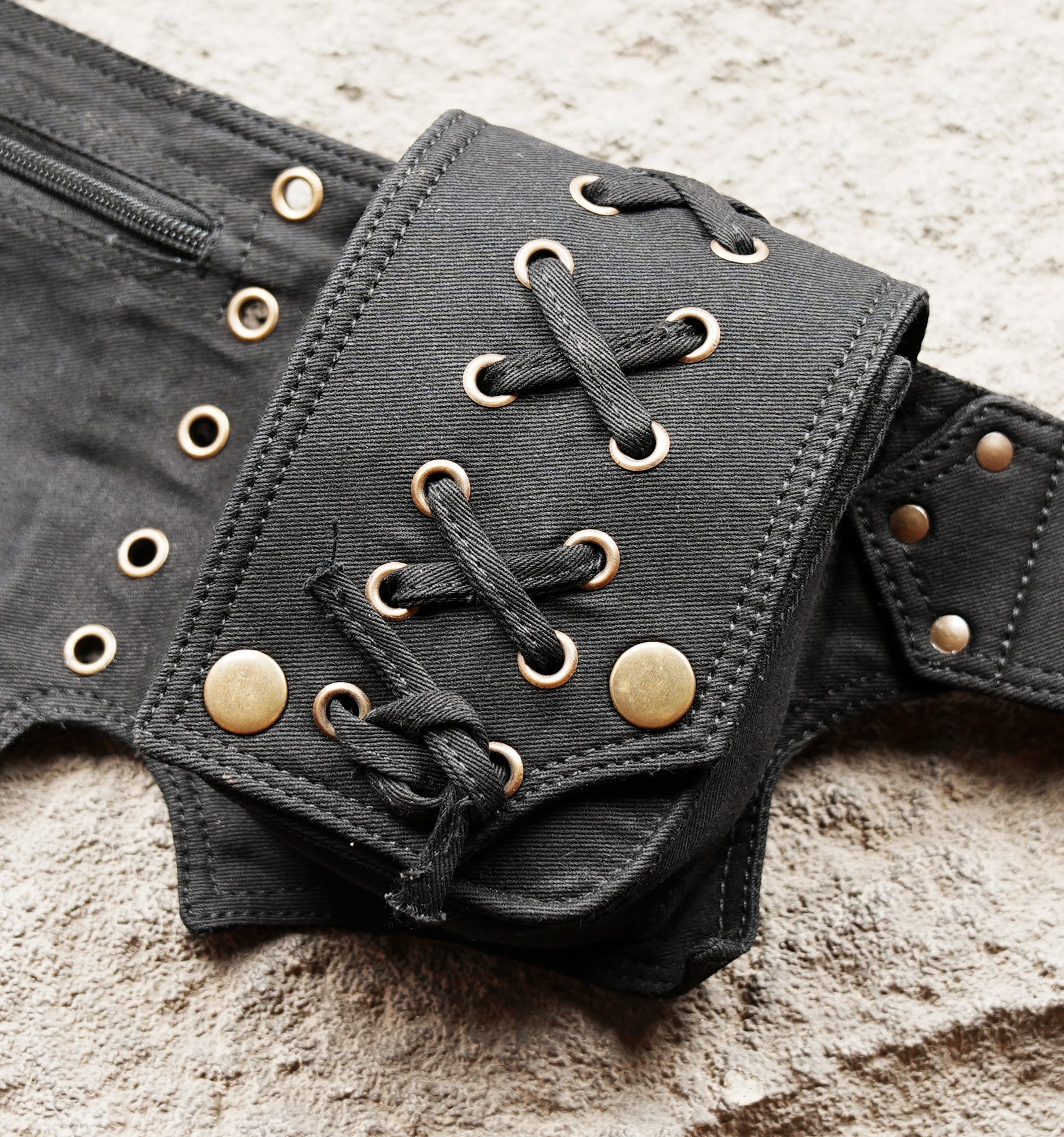 Black waist bag with cargo pouches and antique brass metal hardware
