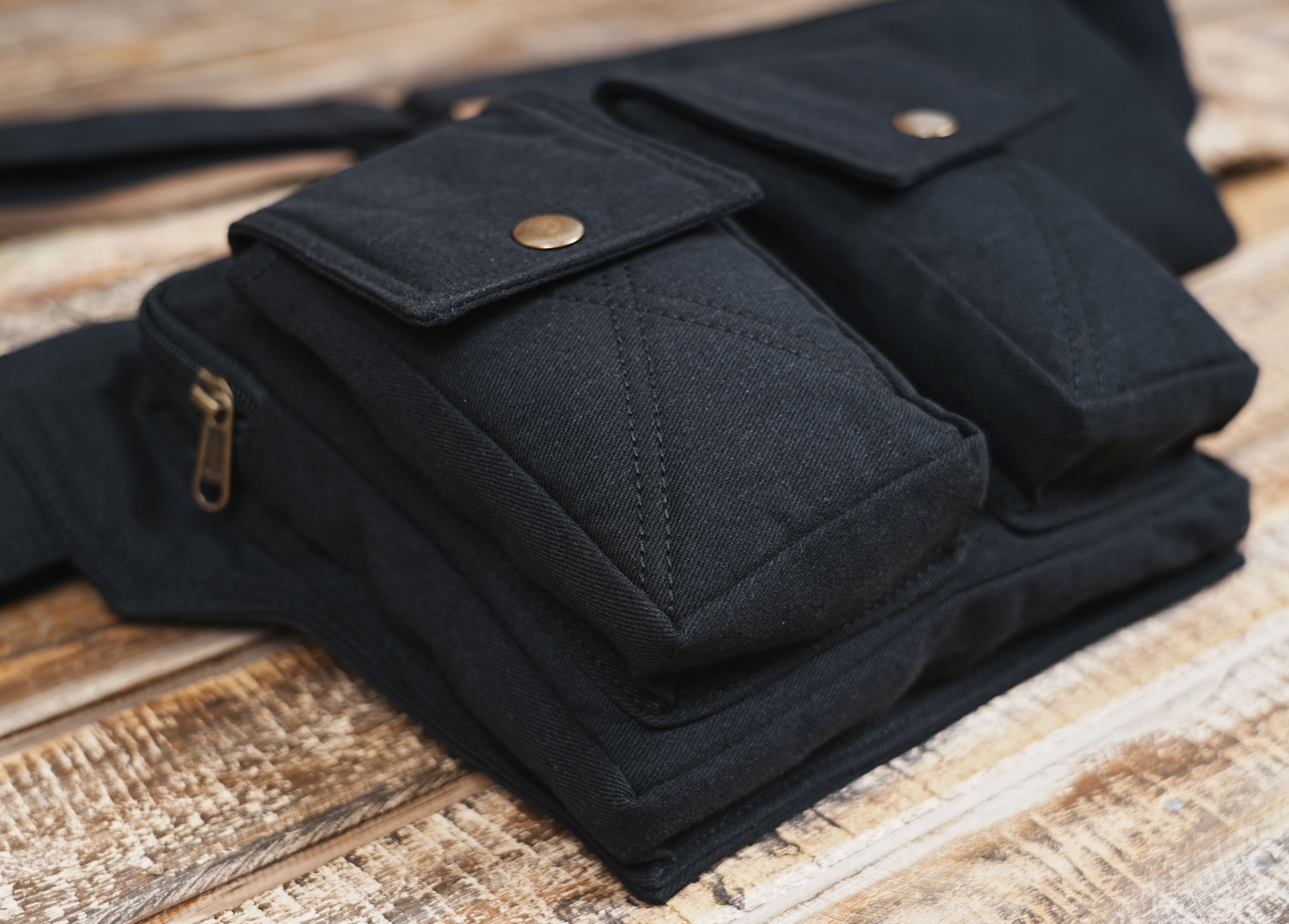 Black tactical waist pack shown fully extended with strap visible
