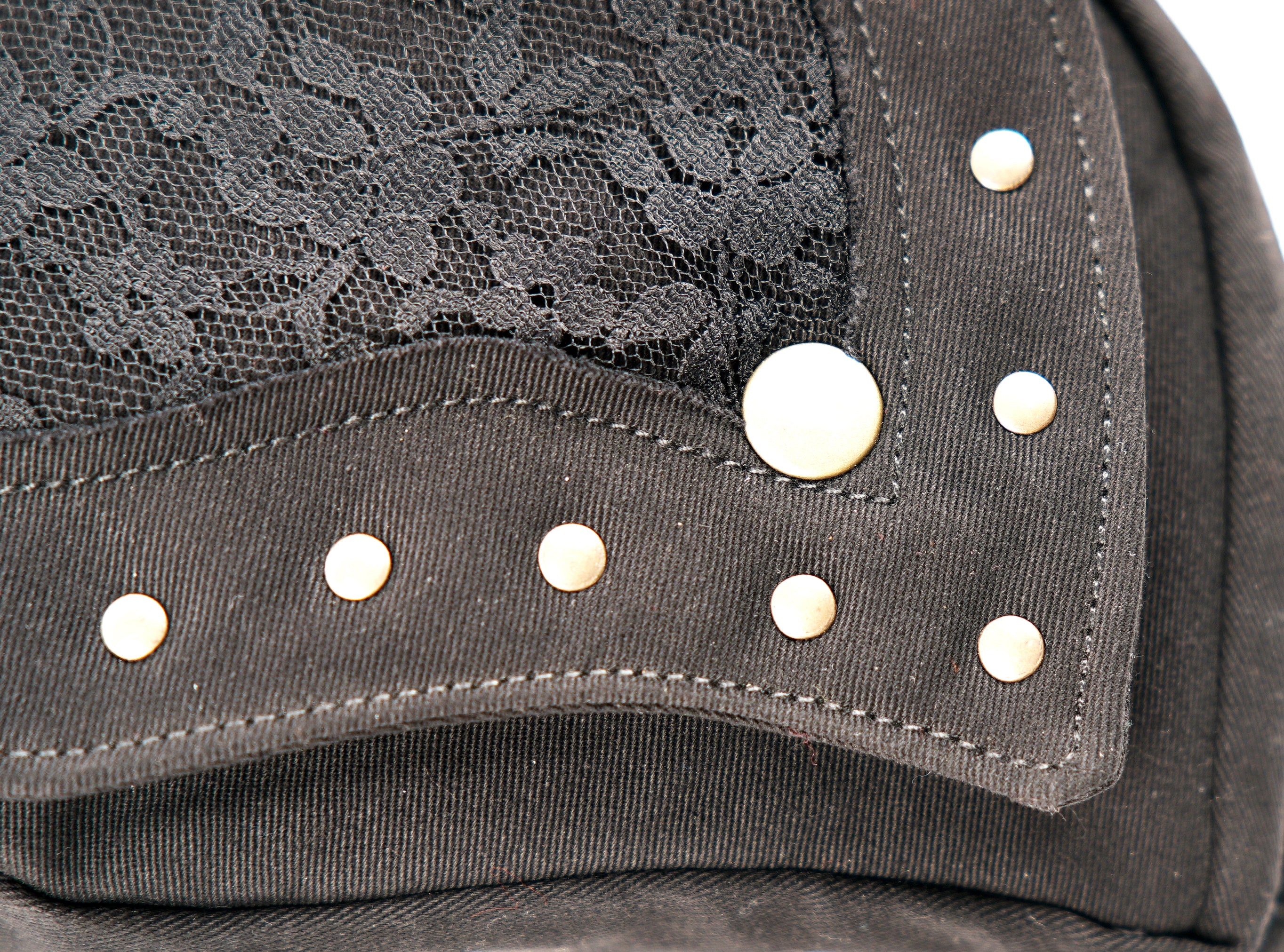 Stylish black fanny pack featuring secure flap closure, metal rivets, and an adjustable canvas belt.