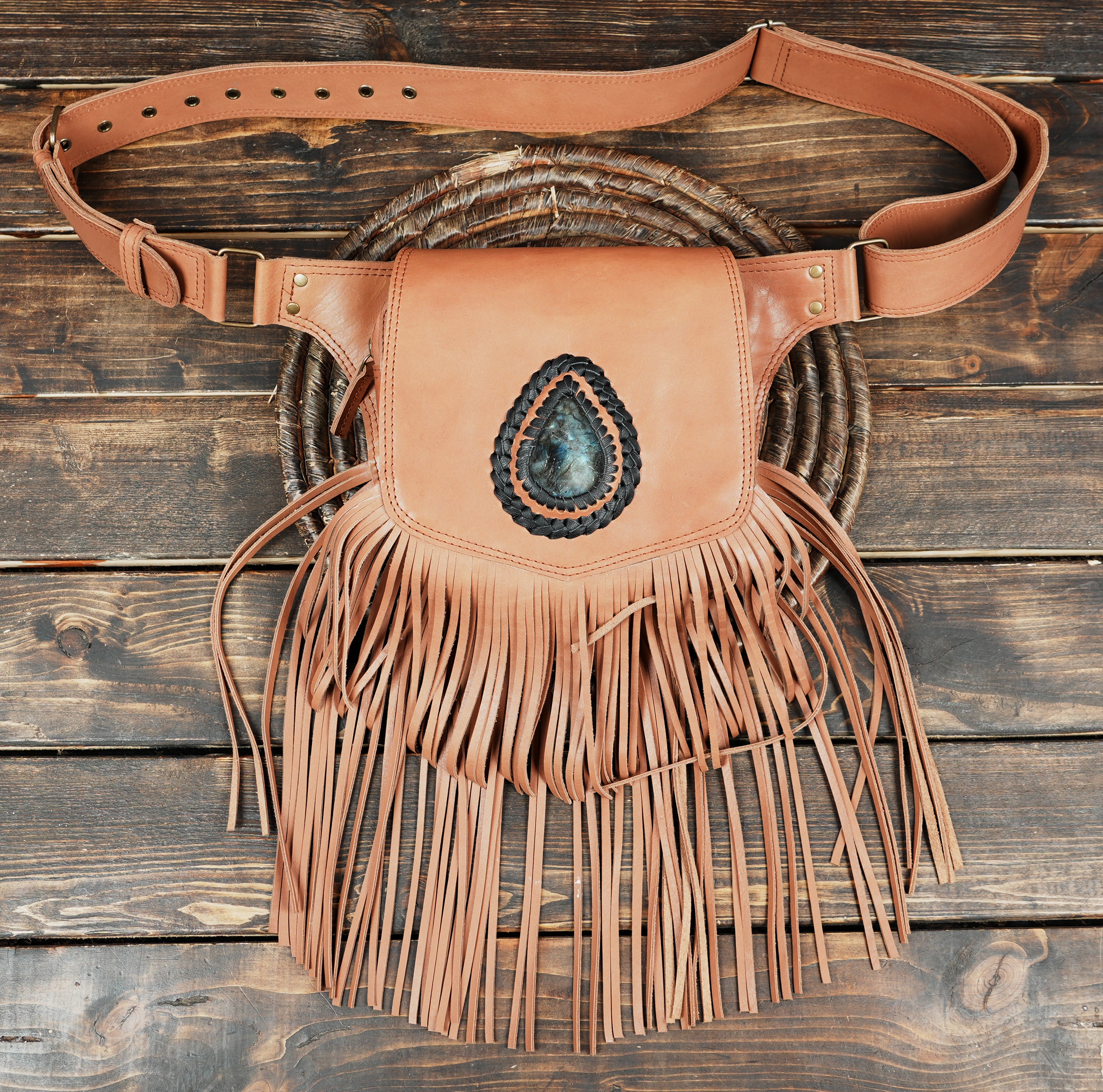 side angle view of fringe holster bag with buckle strap detail