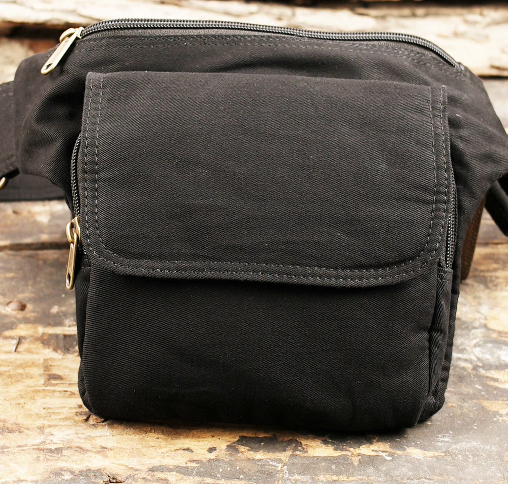 Black canvas utility fanny pack with a front pocket closure
