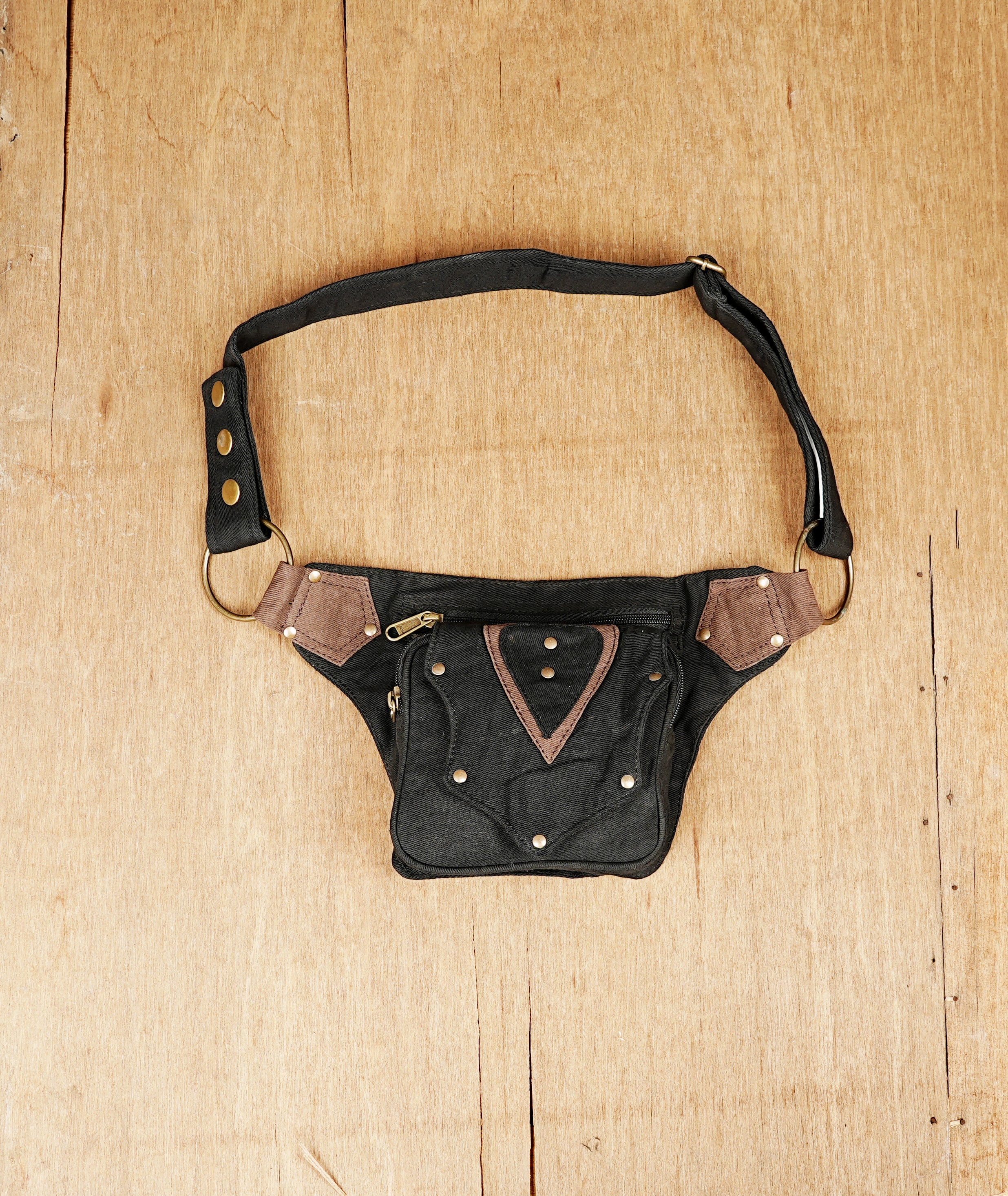 Black canvas fanny pack with unique triangular brown panels and antique brass hardware.