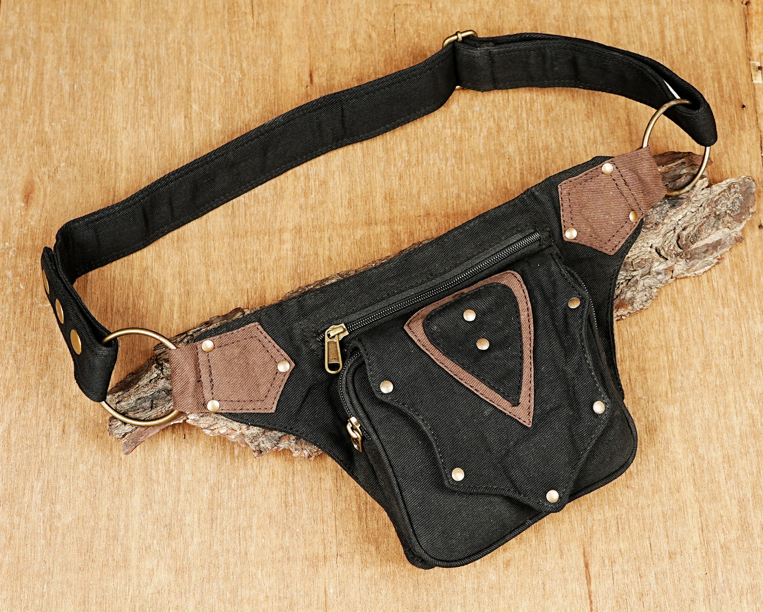 Adjustable utility belt bag made of durable black cotton canvas for travel and festivals.