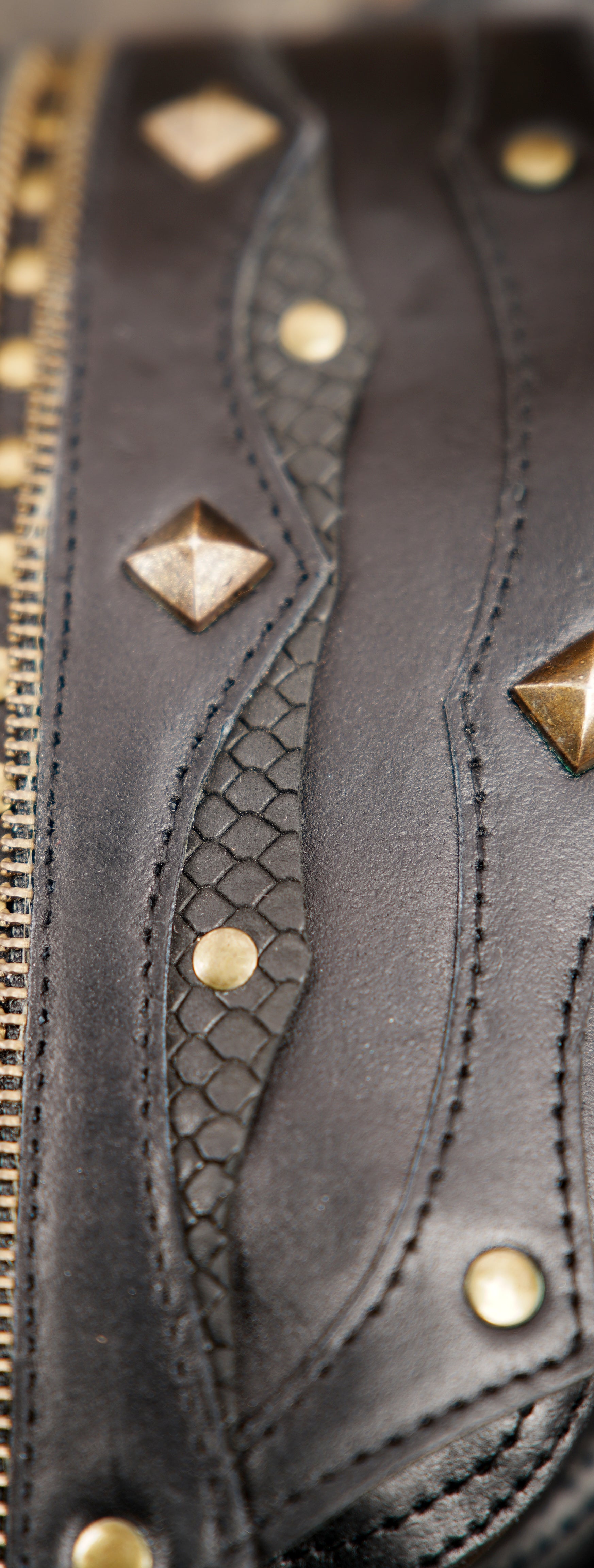 Dual pouch black leather holster with brass hardware and textured panels