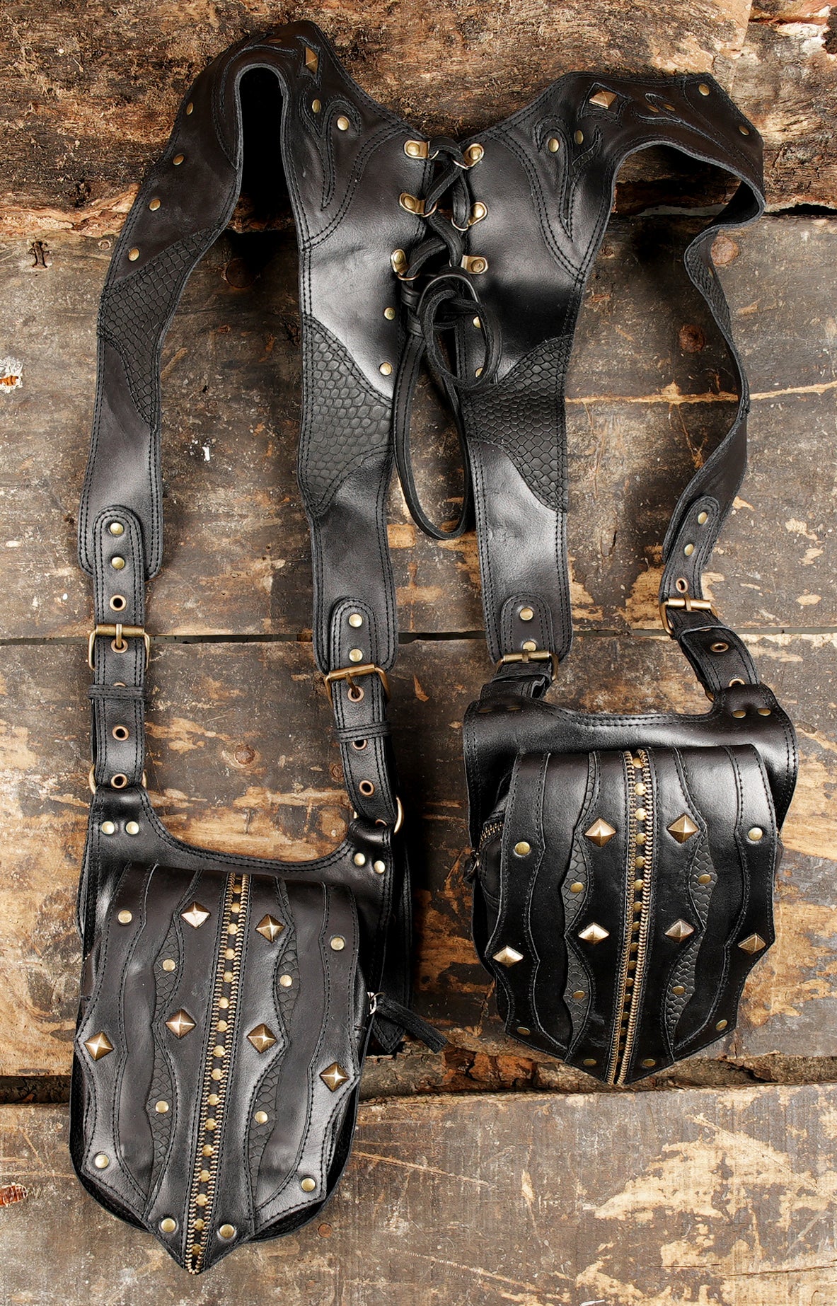 black leather holster bag with brass rivets and lace-up back