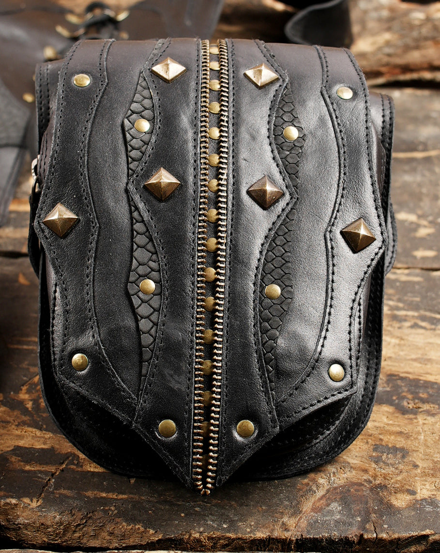 Steampunk style leather holster with metal studs and decorative stitching