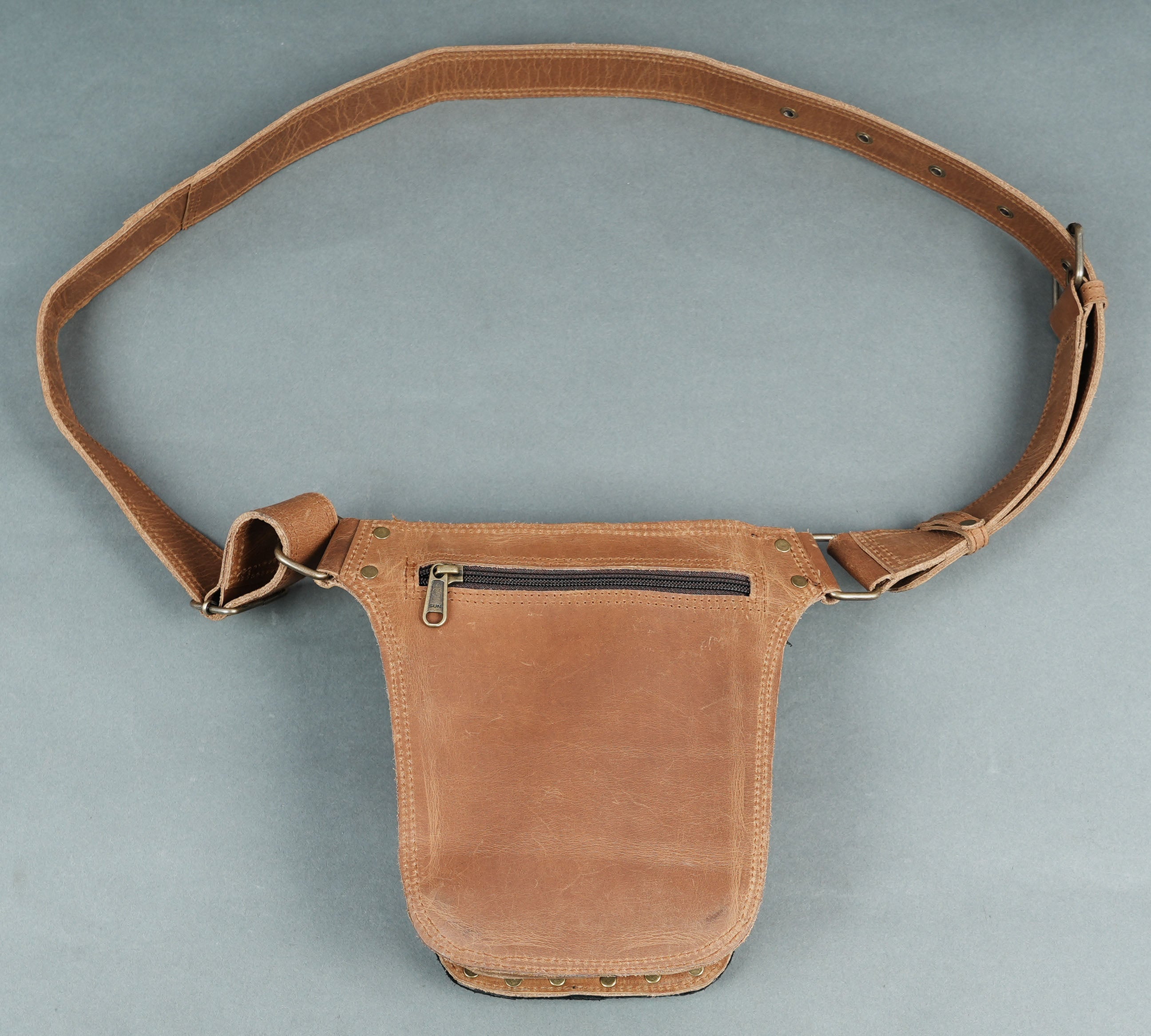 Fashionable brown belt with adjustable strap and strong buckle.