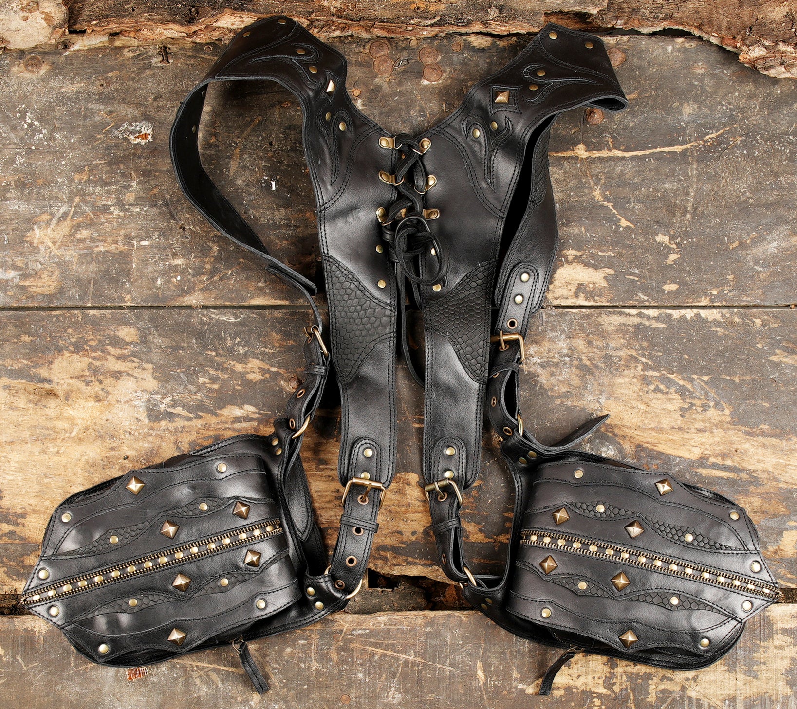 Dual pocket leather holster with brass detailing and zipper accents