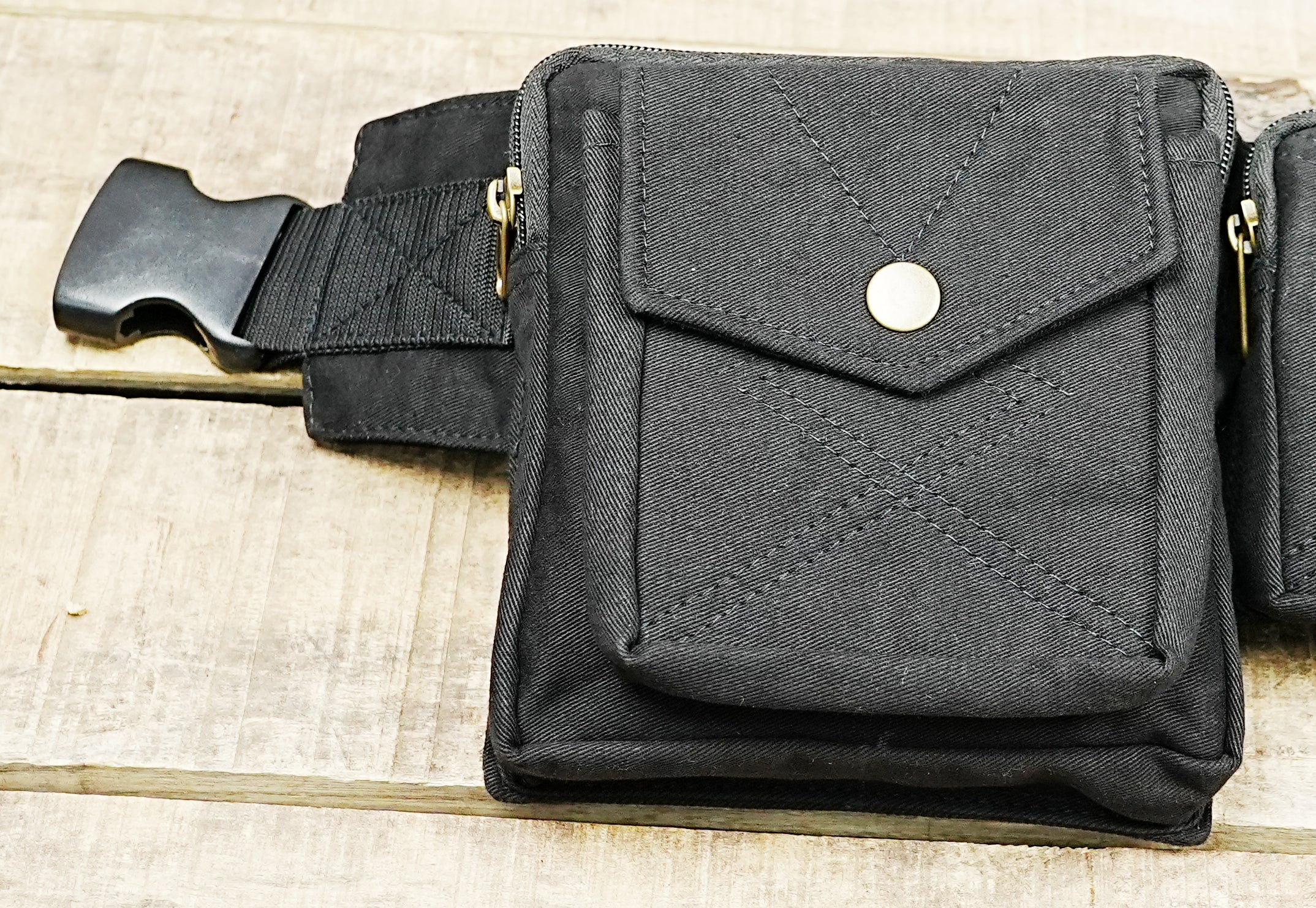Black multi-pocket festival hip bag with adjustable webbing strap and clip buckle