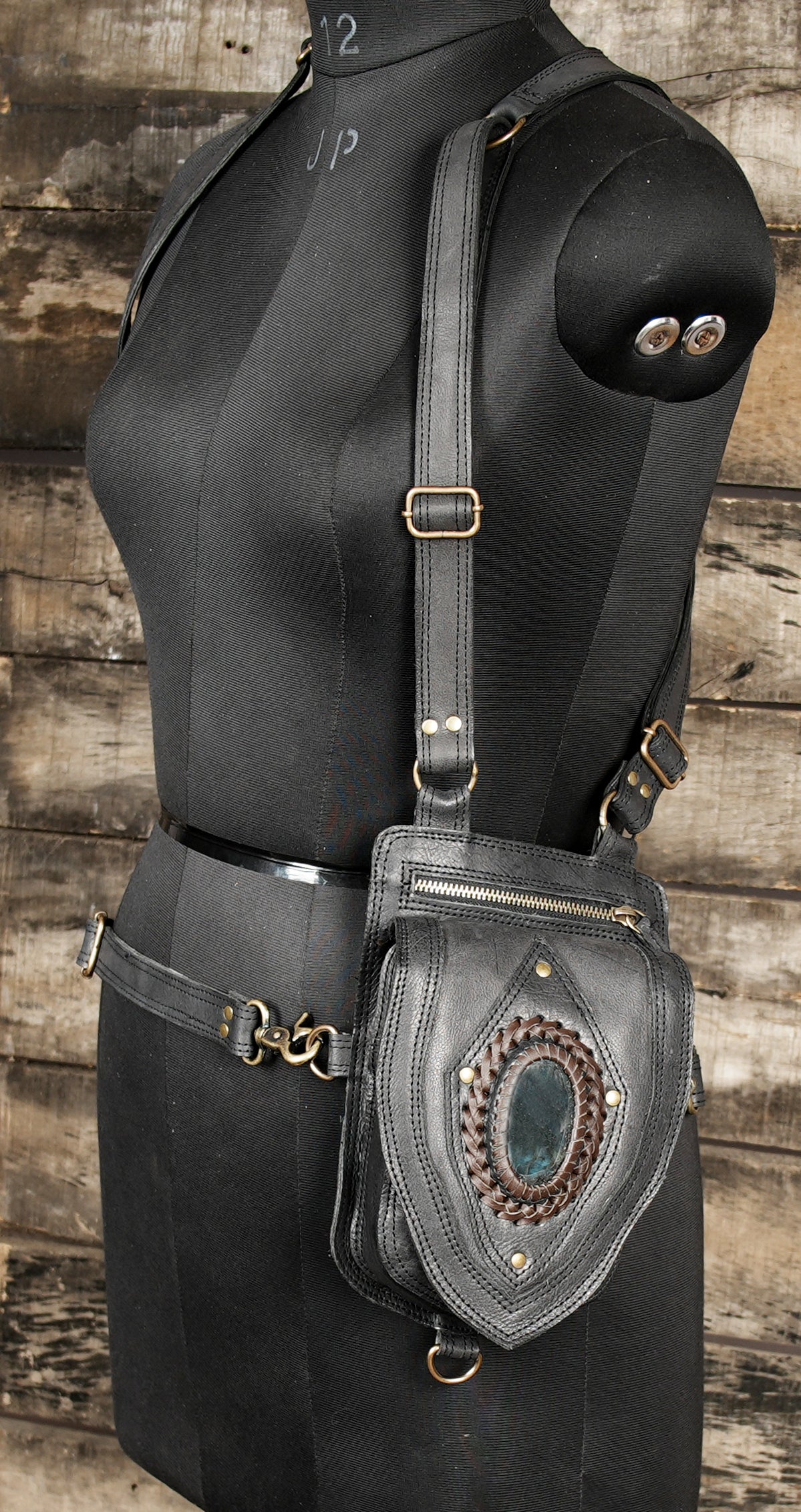 Premium artisan leather holster bag with gemstone centerpiece.