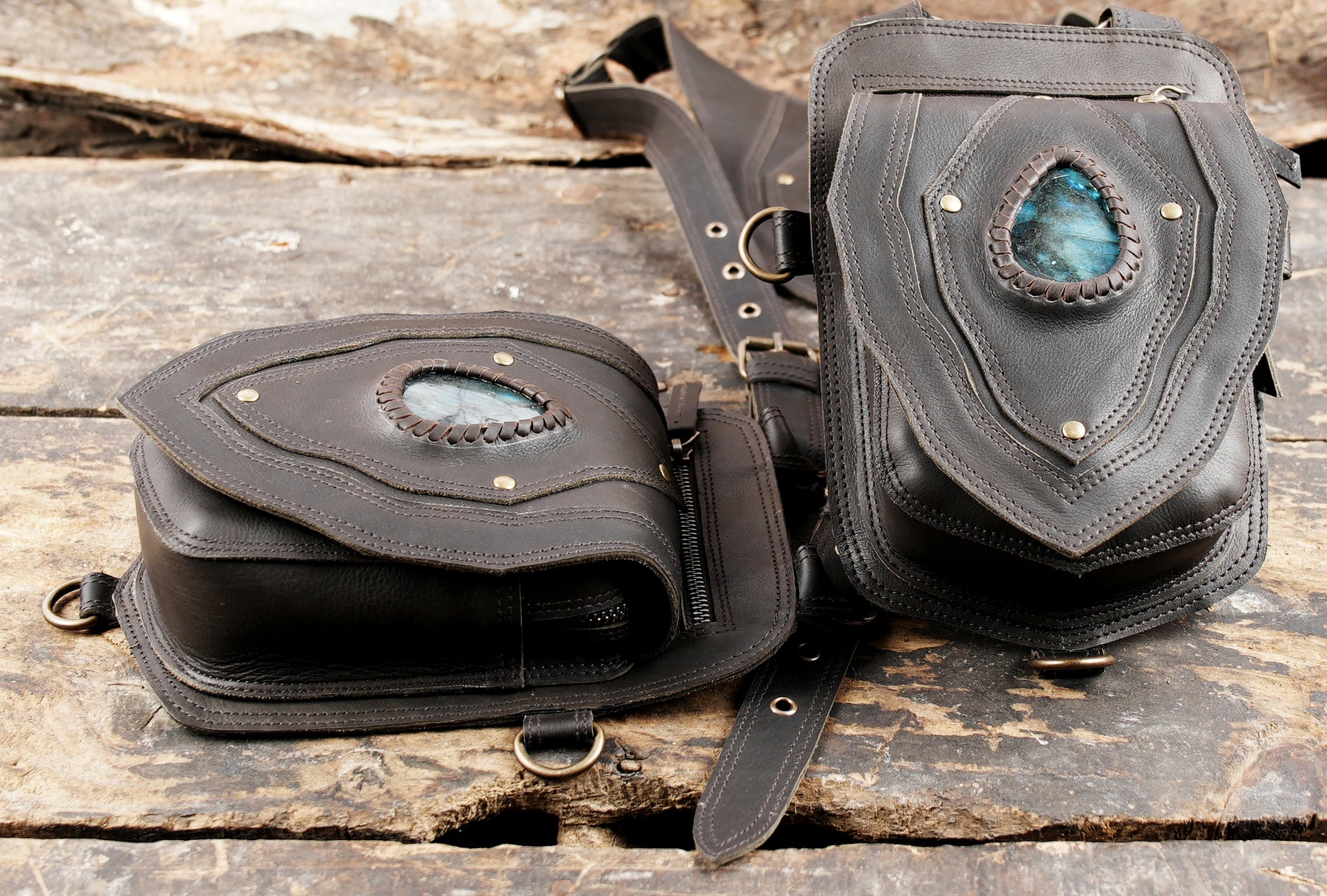 "Black leather holster with brass rivets and hand-stitched edges"