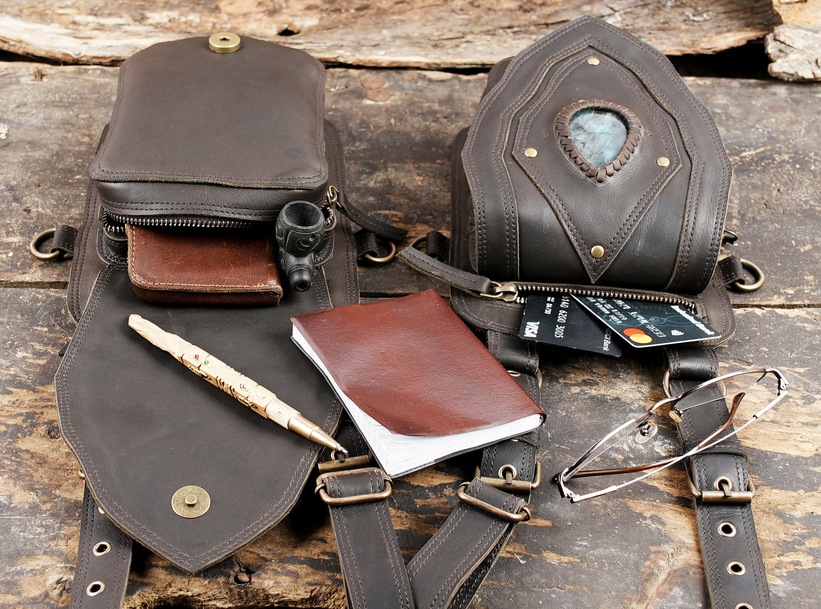 "Black leather shoulder harness with twin pouch holsters"