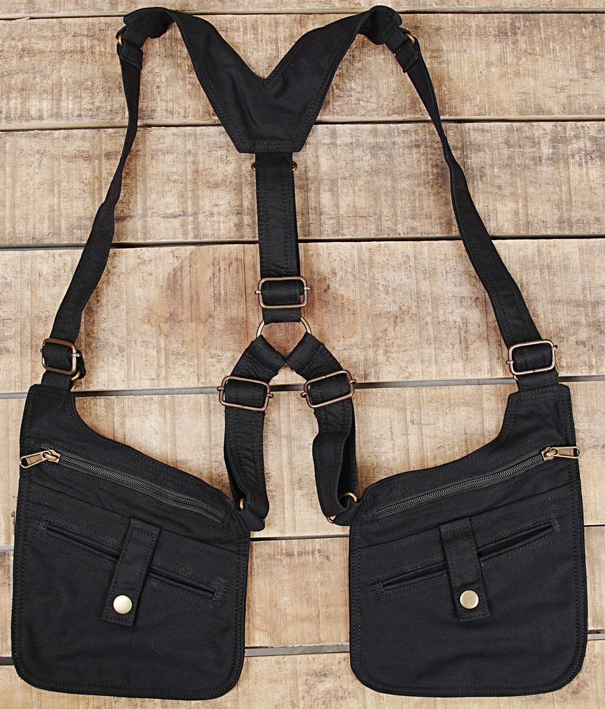 Double shoulder harness bag featuring multi-zipper compartments and front button accents