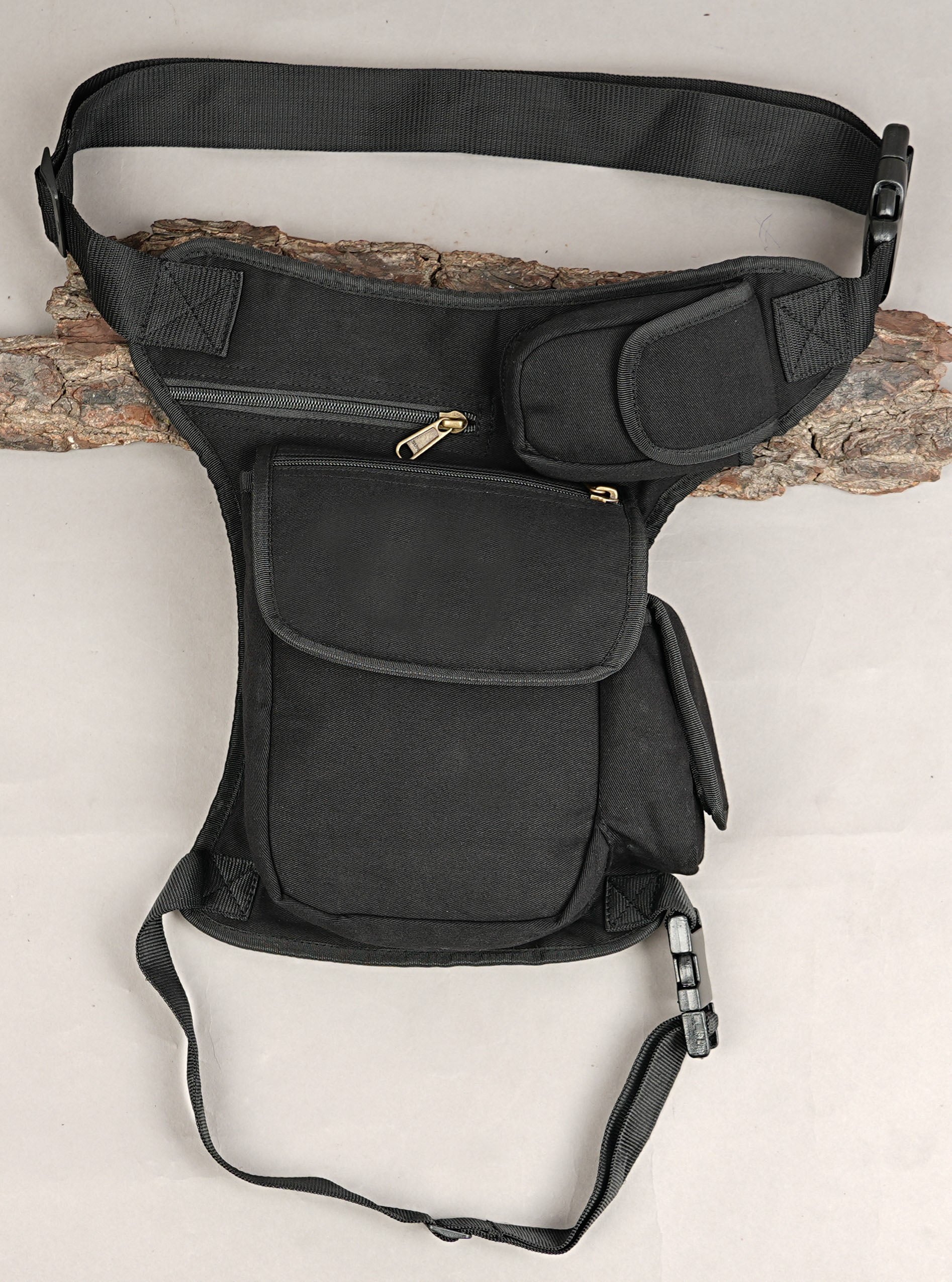Tactical style black canvas side thigh pack with flap pocket and durable buckles.