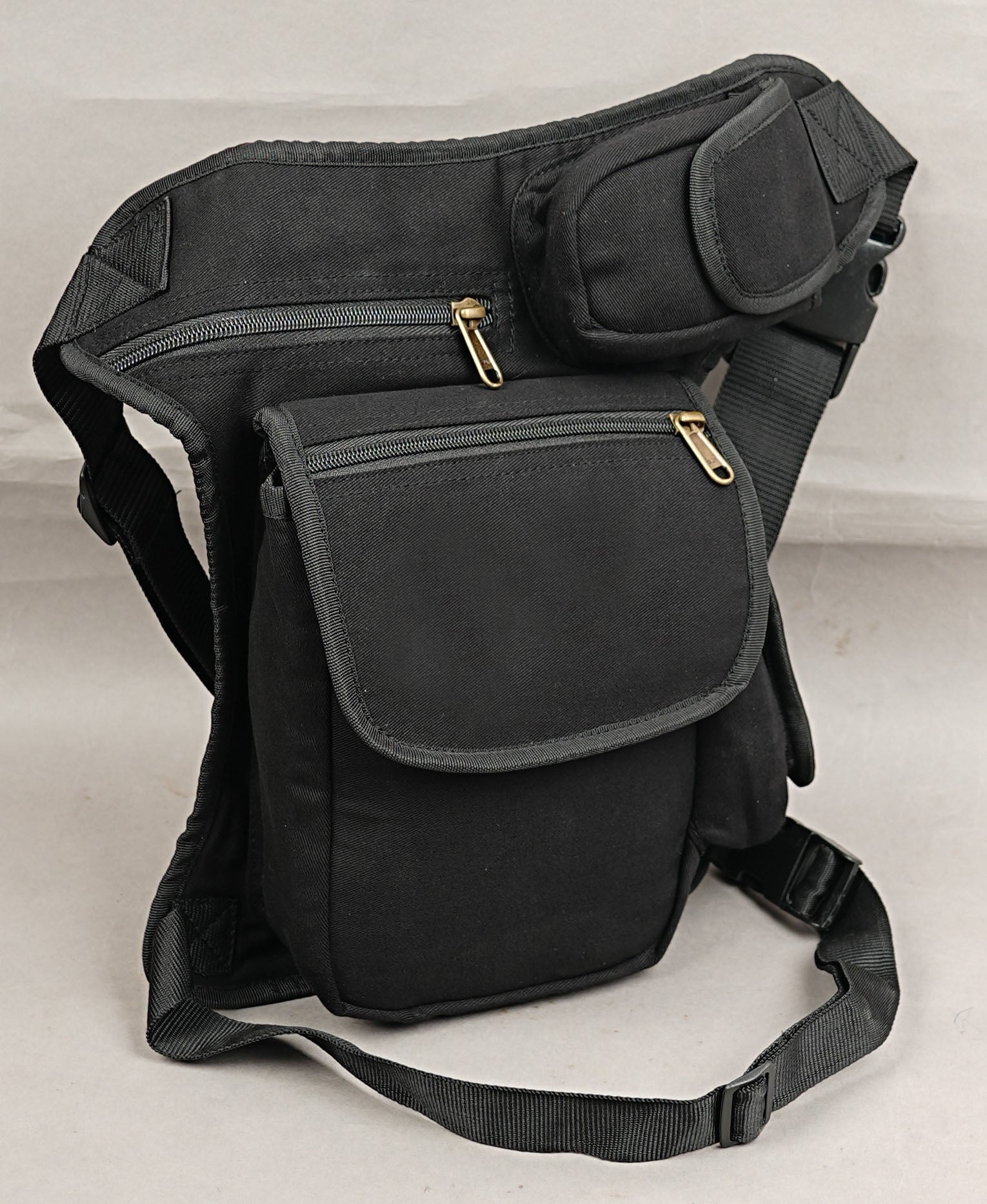 Black festival thigh pocket belt with adjustable leg strap and side phone pouch.