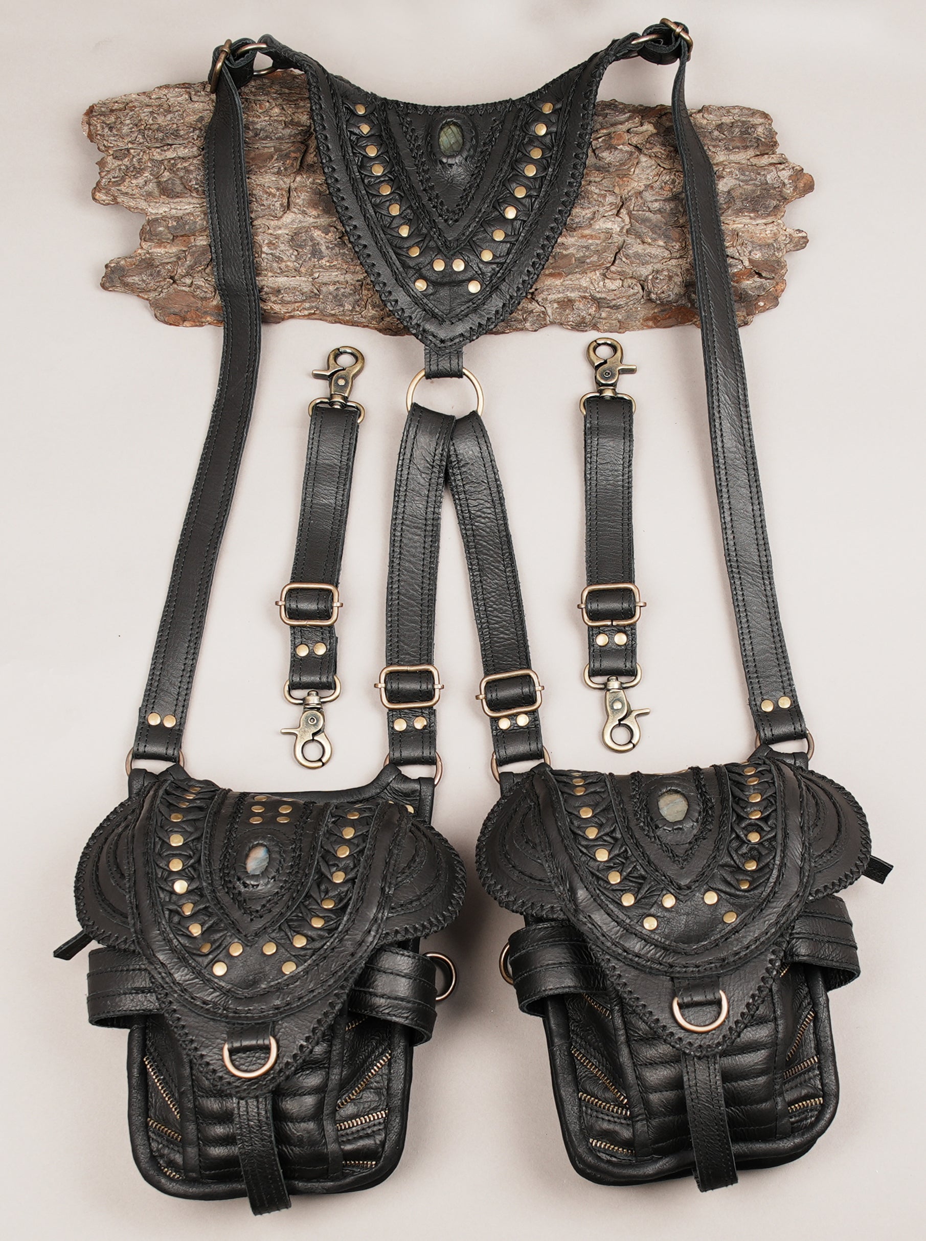 Black  leather travel holster with gemstone accents and adjustable straps”