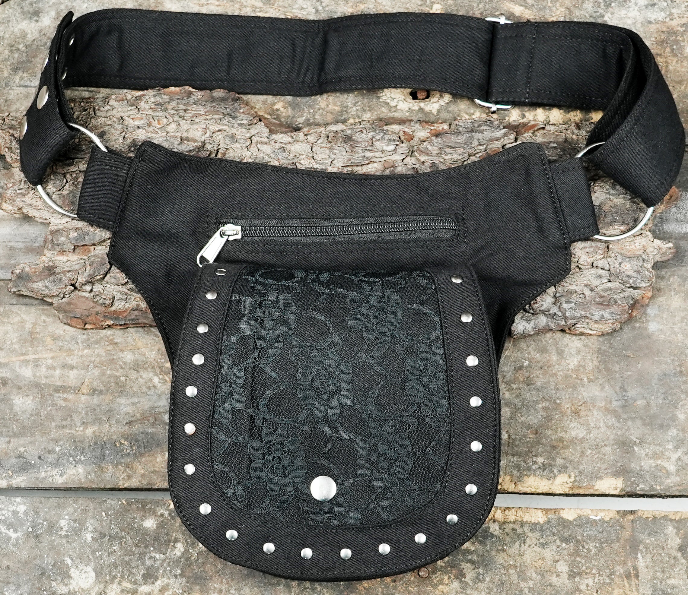 Multi-pocket waist bag made from robust black cotton canvas with zipper and secure flap closures.