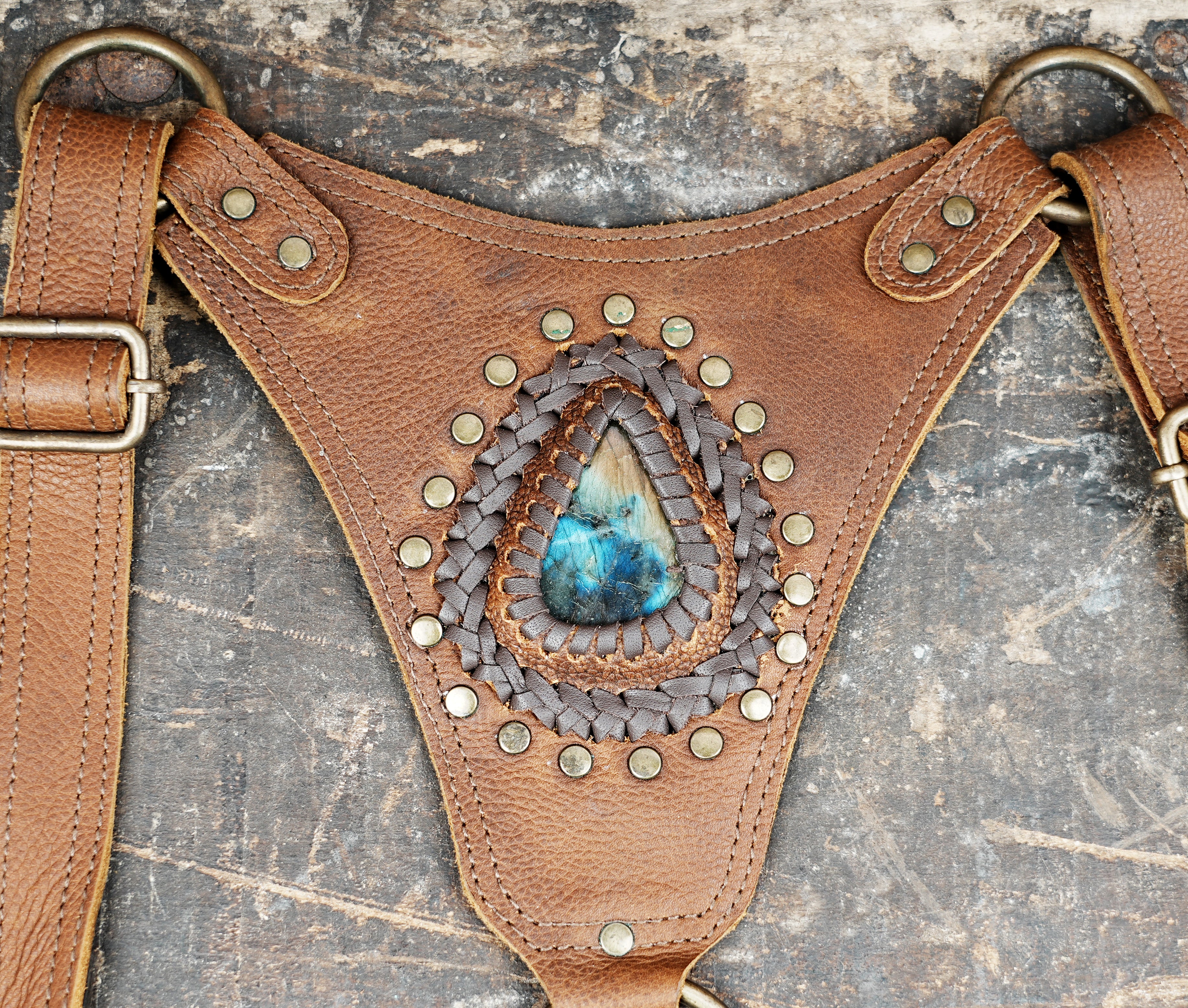 “Handcrafted brown leather shoulder holster with dual pouches and tribal detailing”