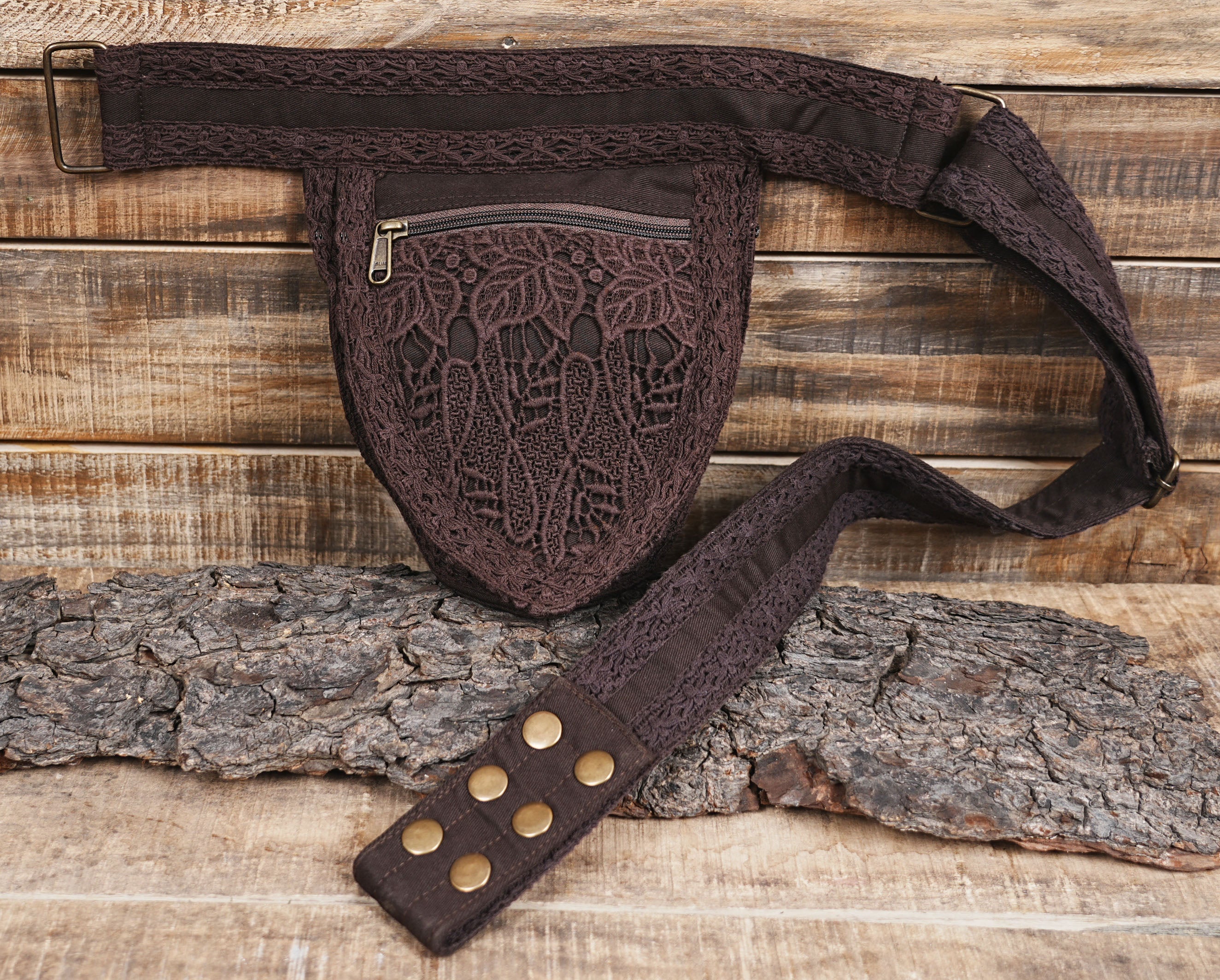 Handcrafted brown cotton hip bag displayed on natural wood