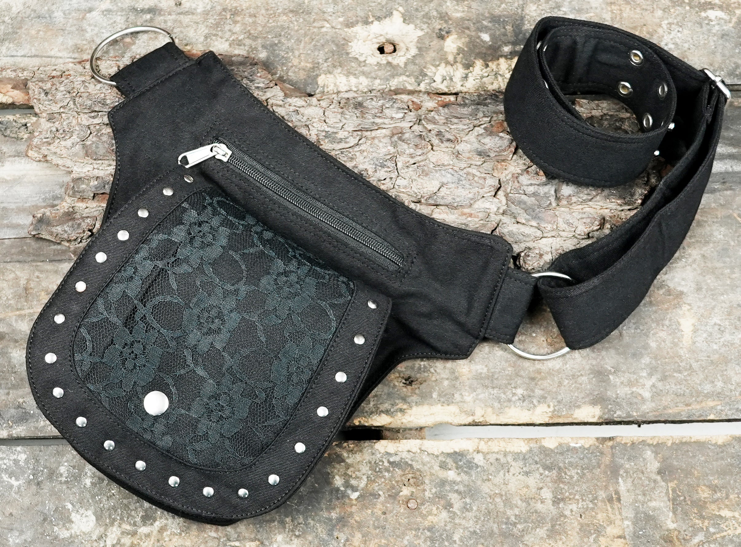 A secure travel companion: multi-pouch black canvas fanny pack / bum bag with metal hardware.