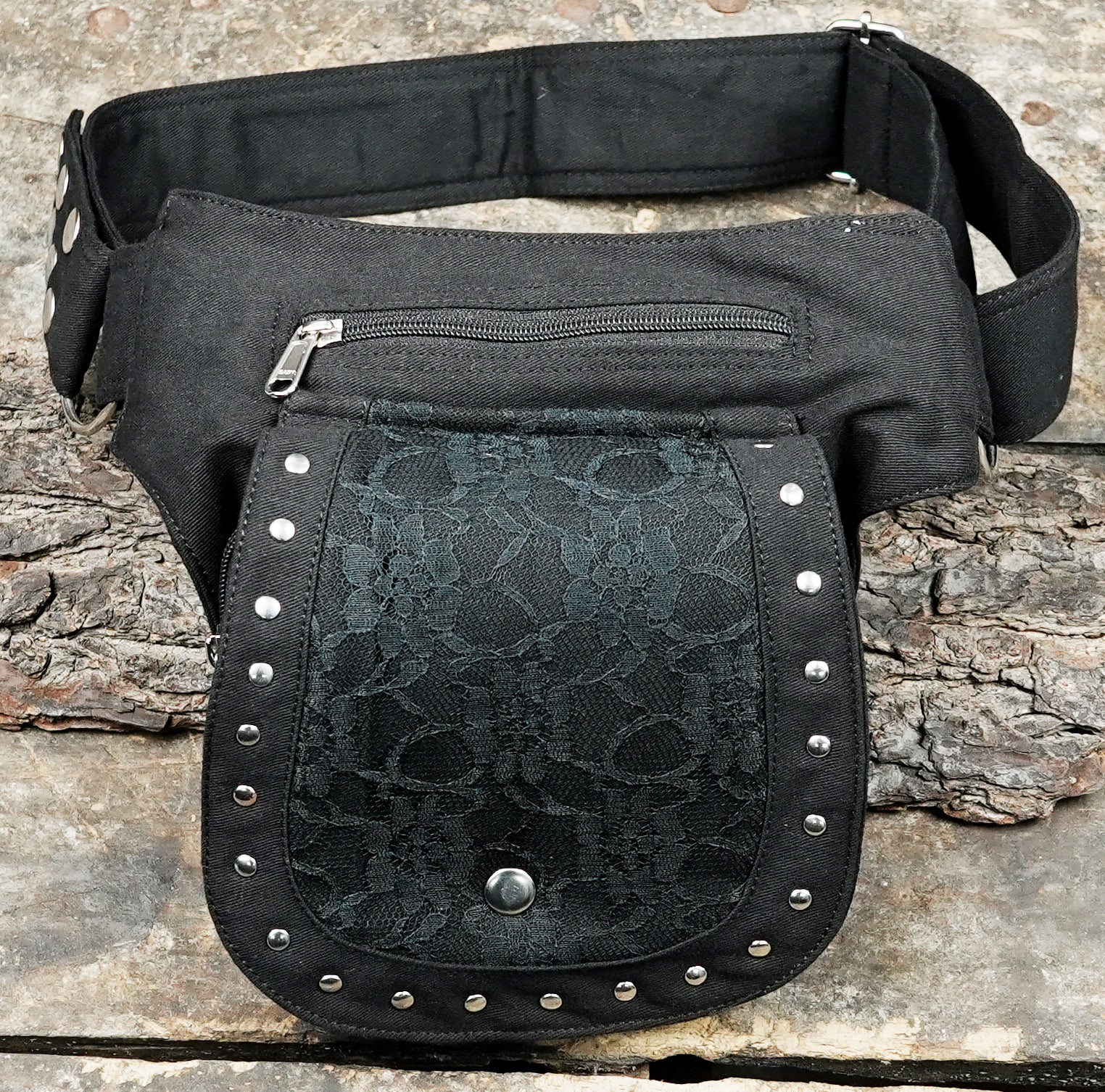 Premium alternative fashion hip pack with secure metal riveted details and durable stitching.