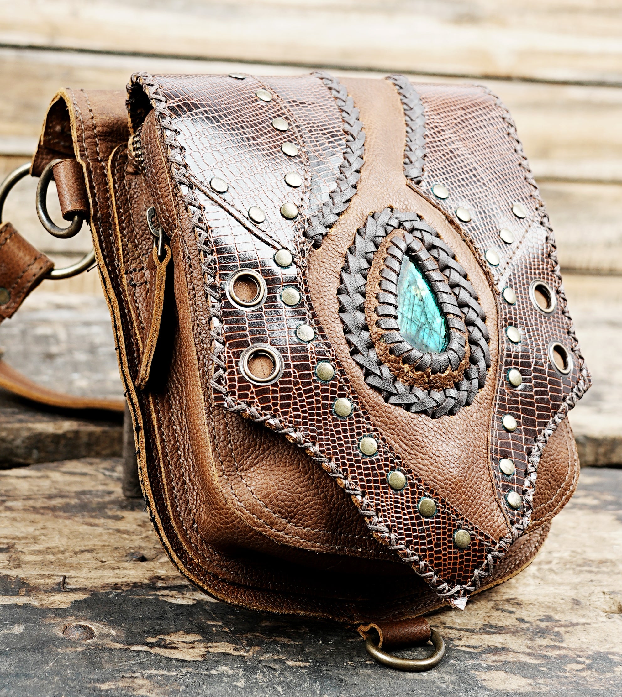 “Brown crossbody holster with reptile-pattern leather and studded accents”