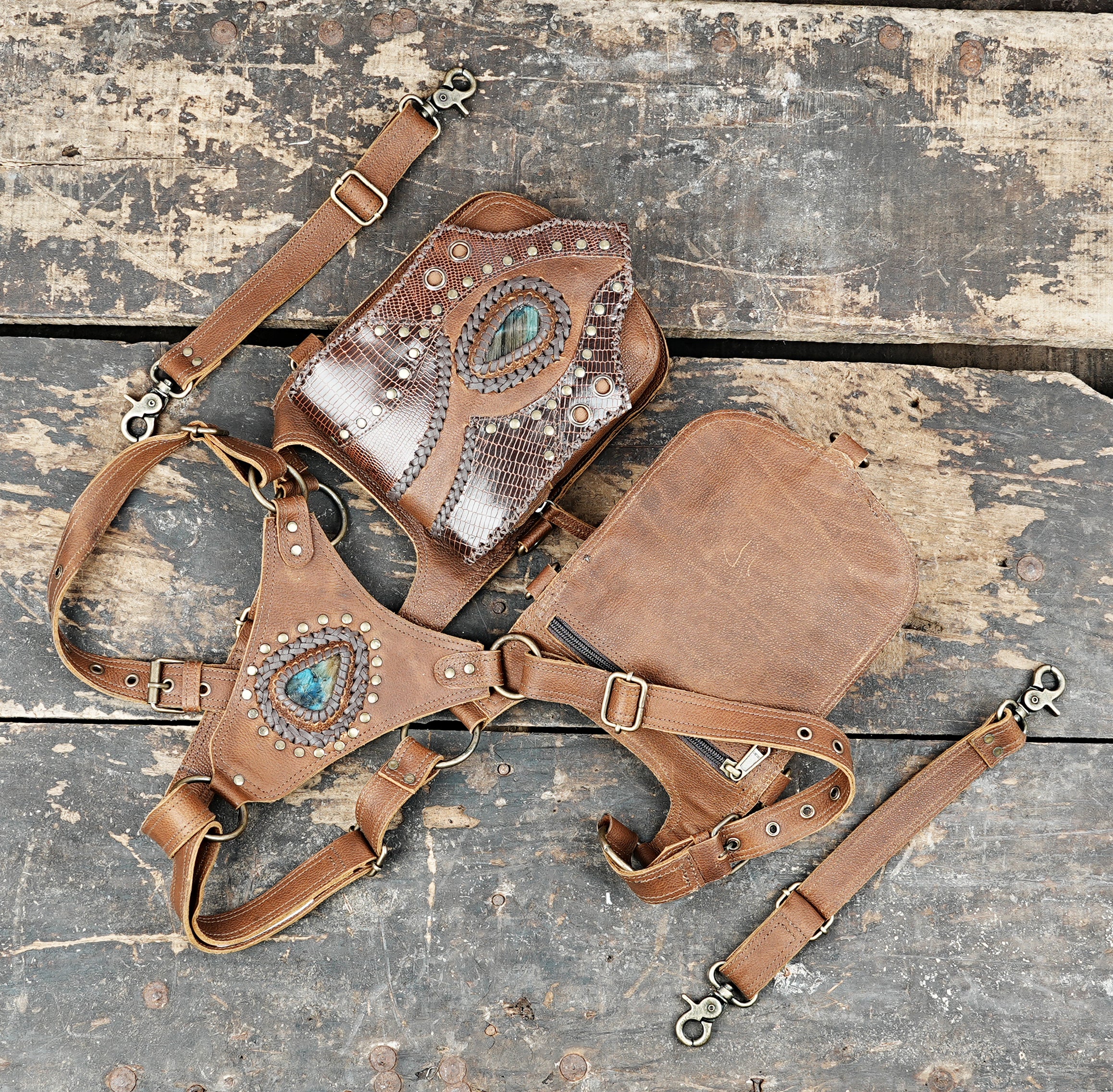 “Dual pouch leather shoulder rig with reptile texture and tribal-inspired details”