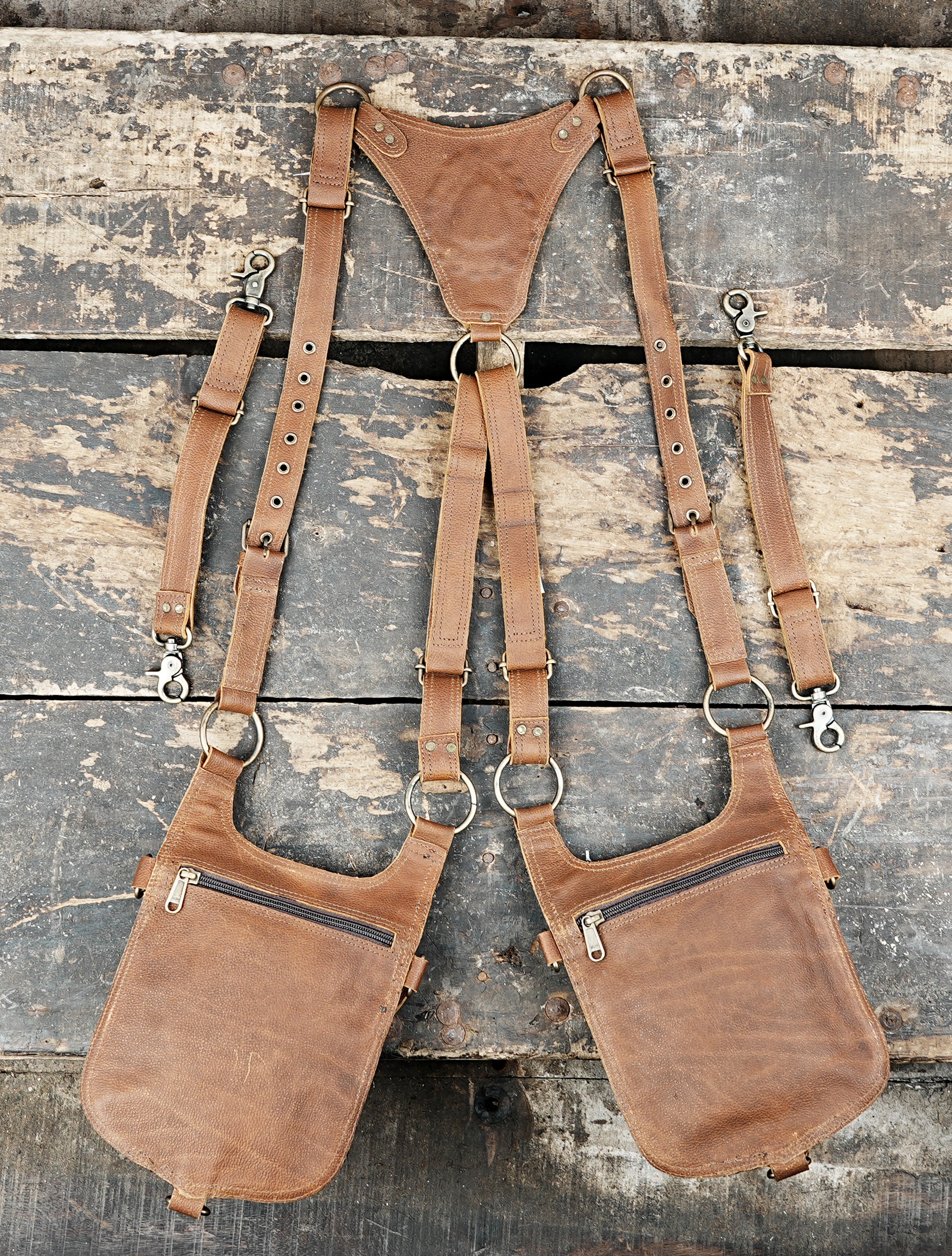 “Brown leather harness holster with gemstone focal point and brass studs”
