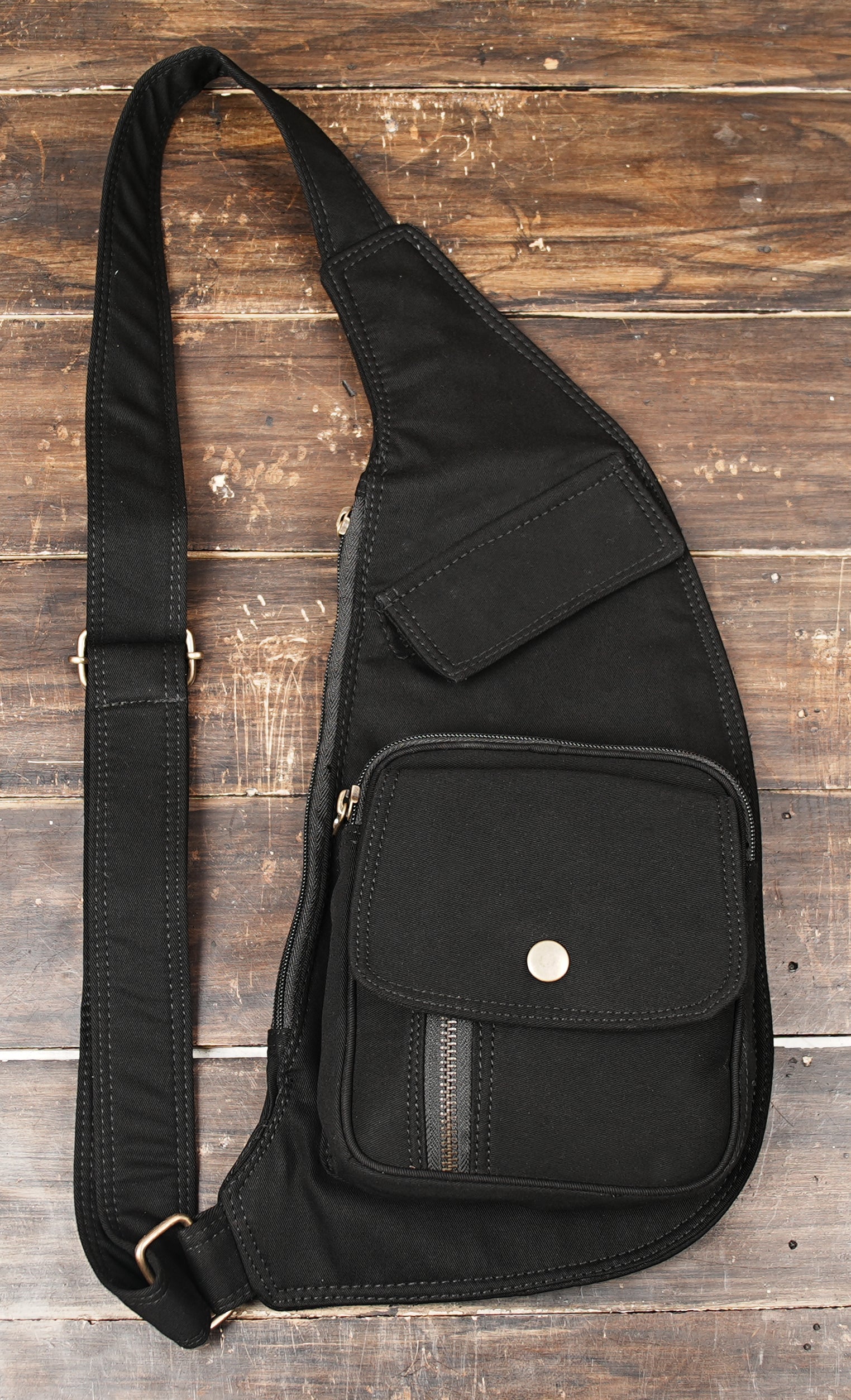 Unisex canvas shoulder bag featuring a single adjustable strap and multi-pockets
