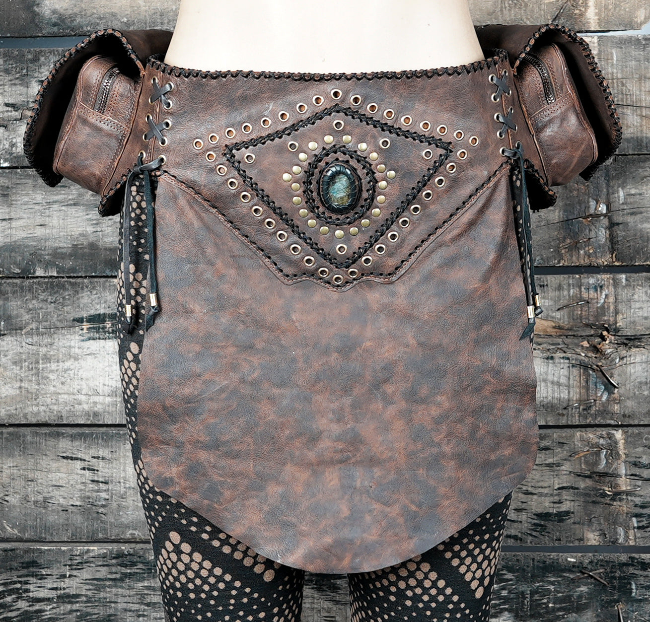 Tribal-inspired leather belt with skirt flap and storage pockets