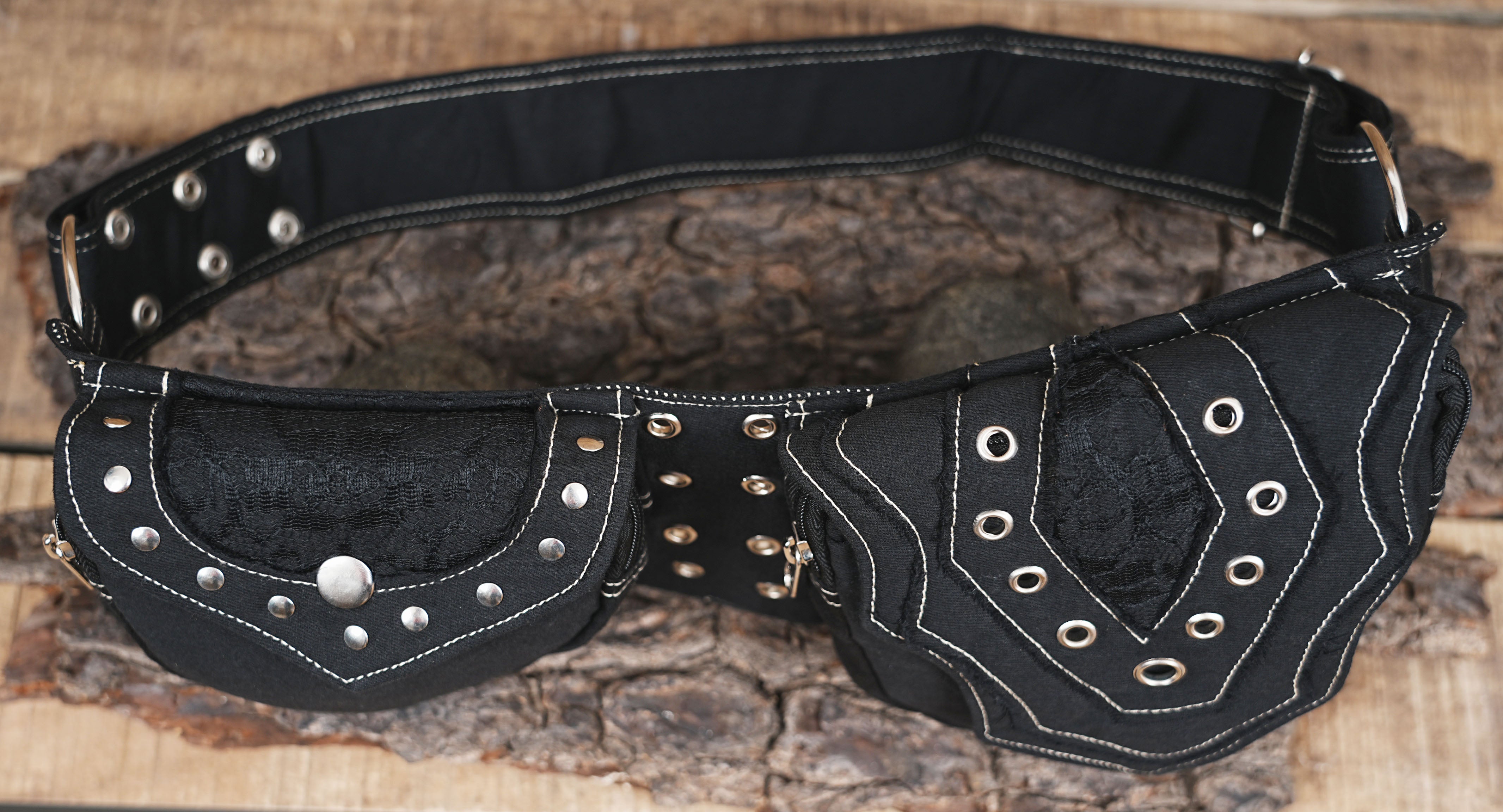 Multiple-pocket black waist bag with heavy metal hardware and layered fabric design.
