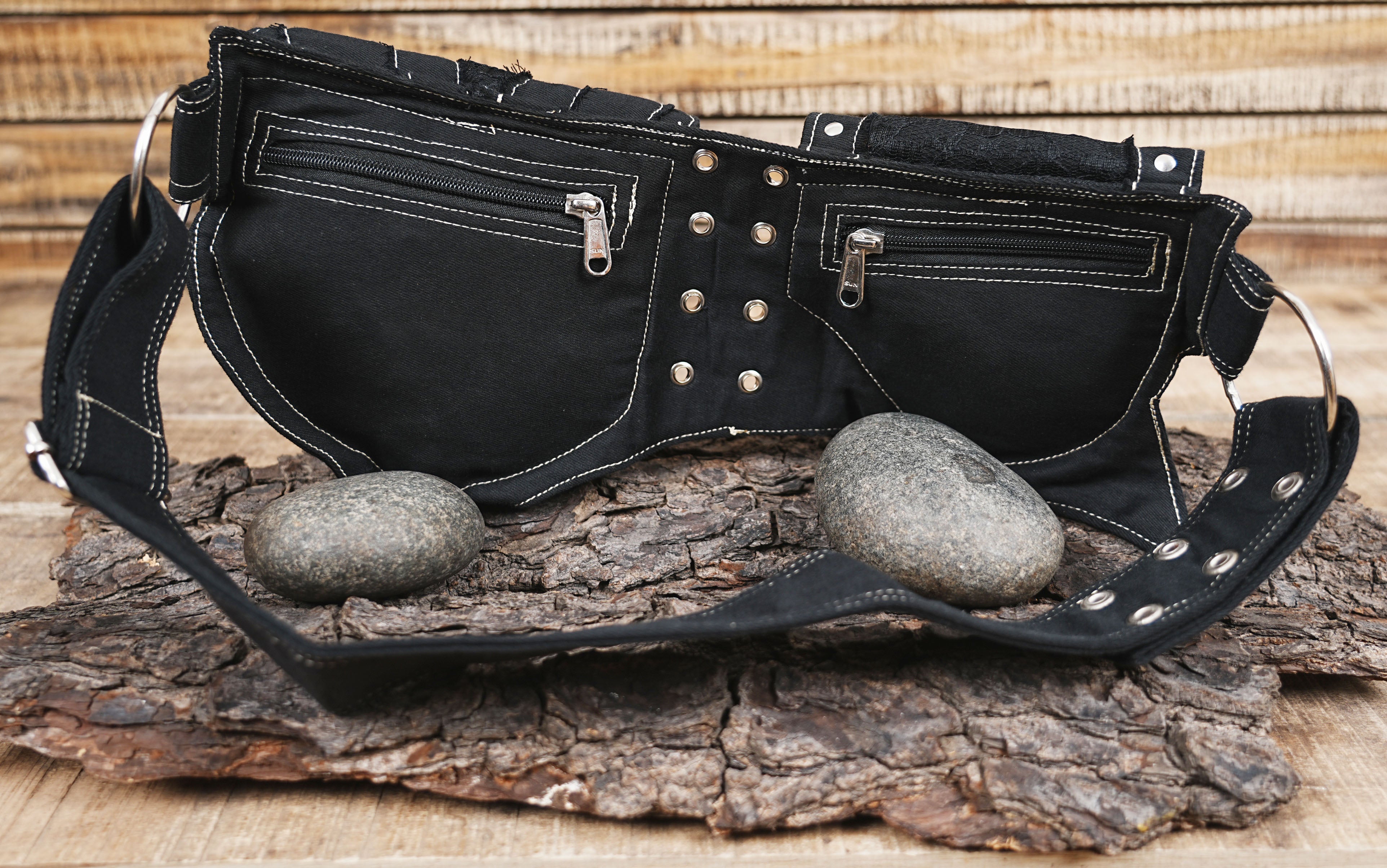 Unique black canvas waist bag with gothic embellishments and a structured multi-pocket layout.