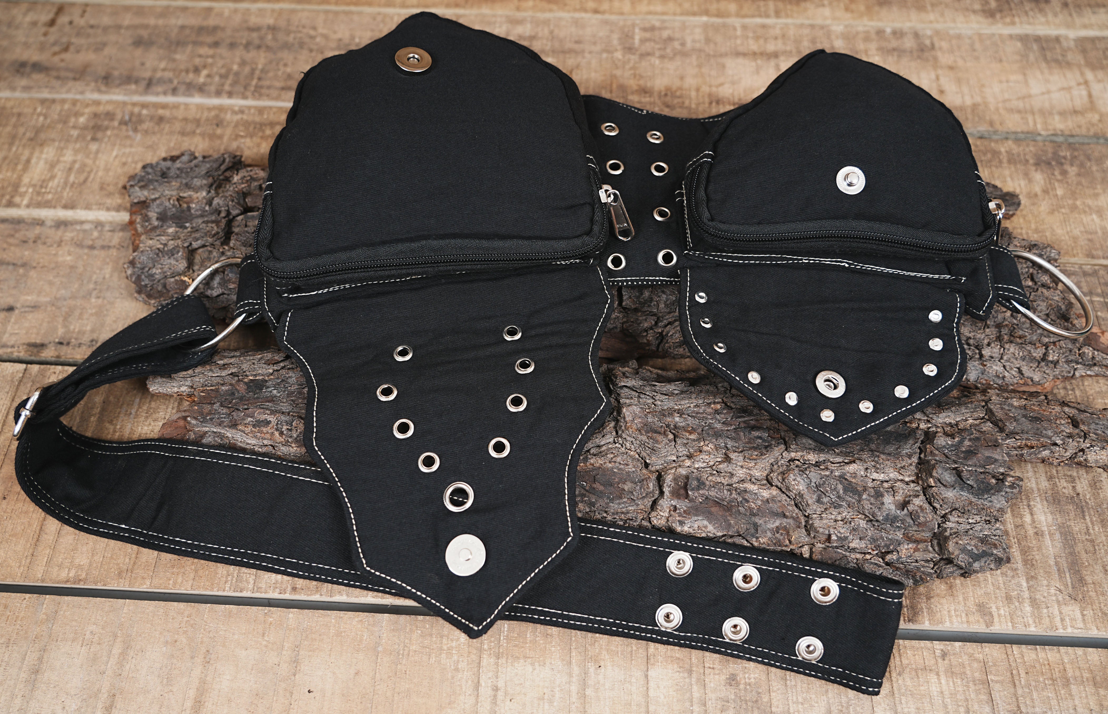 Alternative fashion hip pouch with integrated grommets and layered canvas details.
