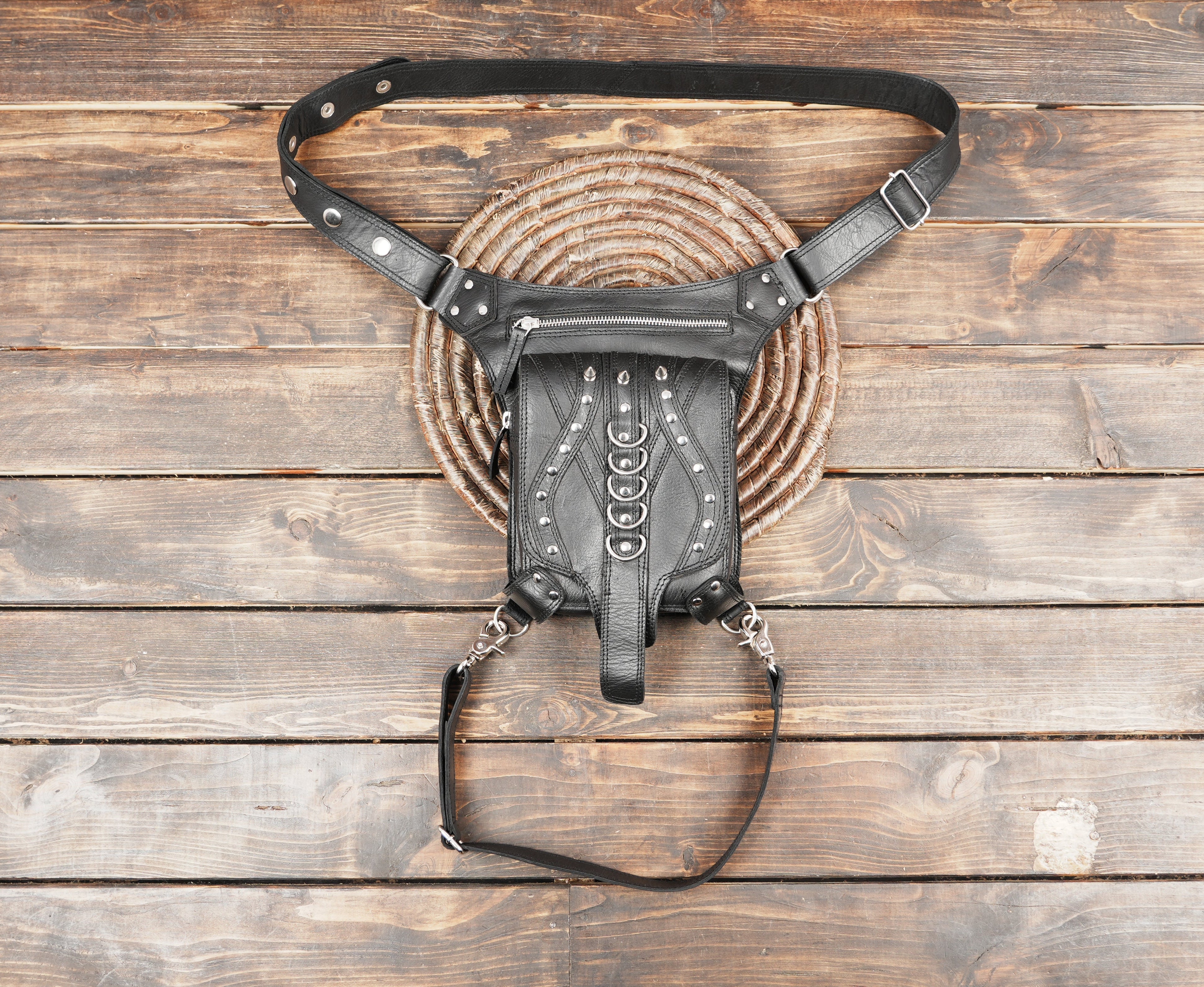 Black leather waist thigh belt with adjustable straps and metal rings