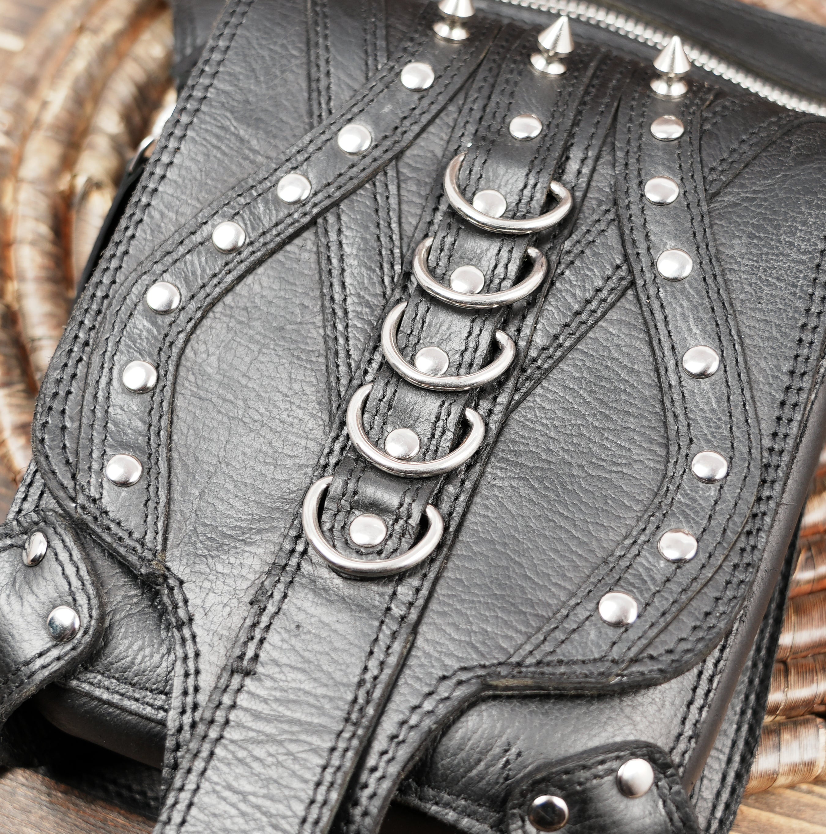 Black leather harness belt worn on waist and thigh