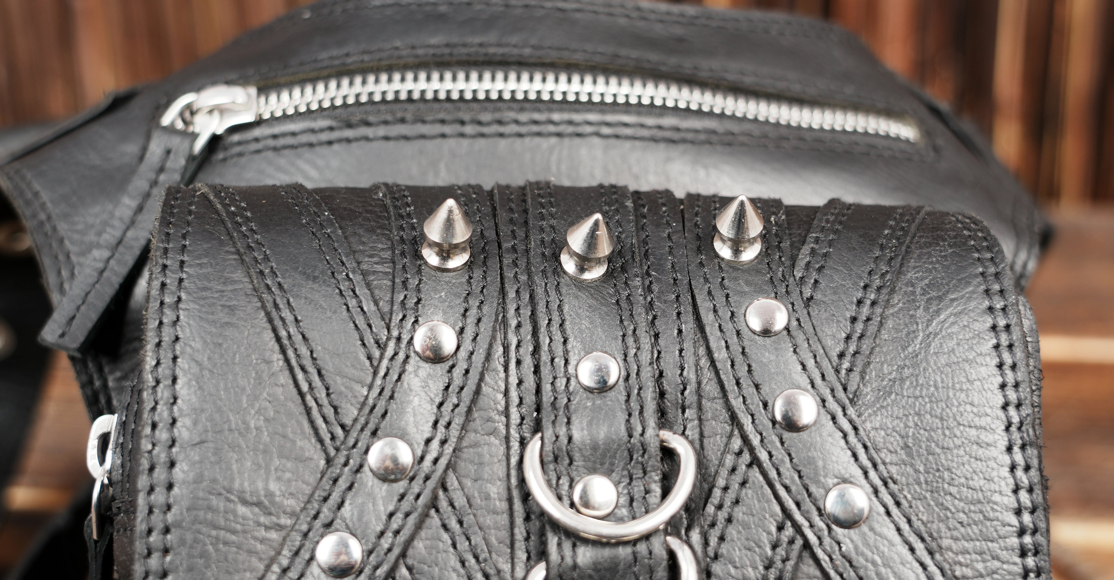 Adjustable leather thigh belt with metal buckles and studs