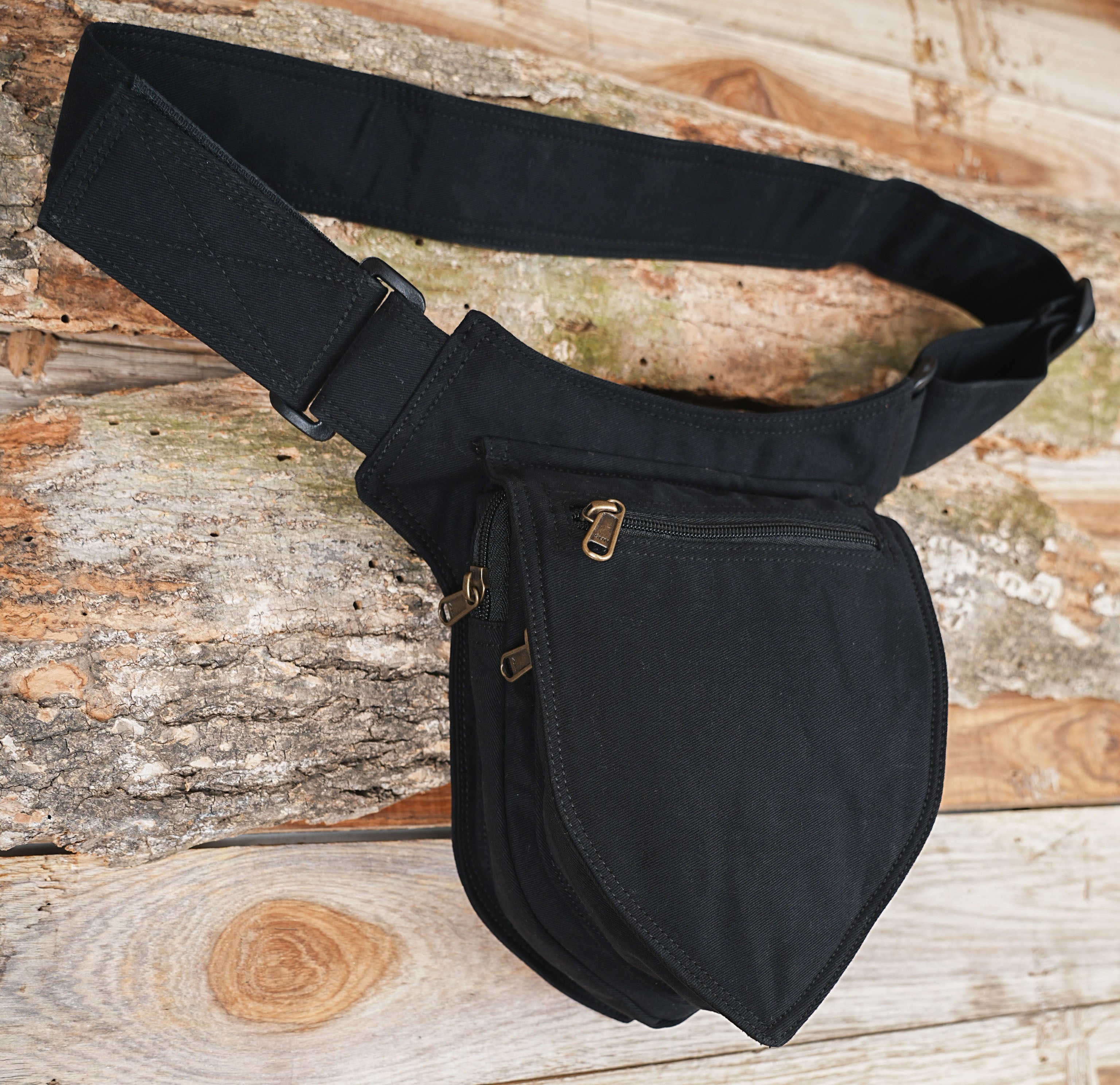 Black waist bag with brass zip pull and adjustable strap