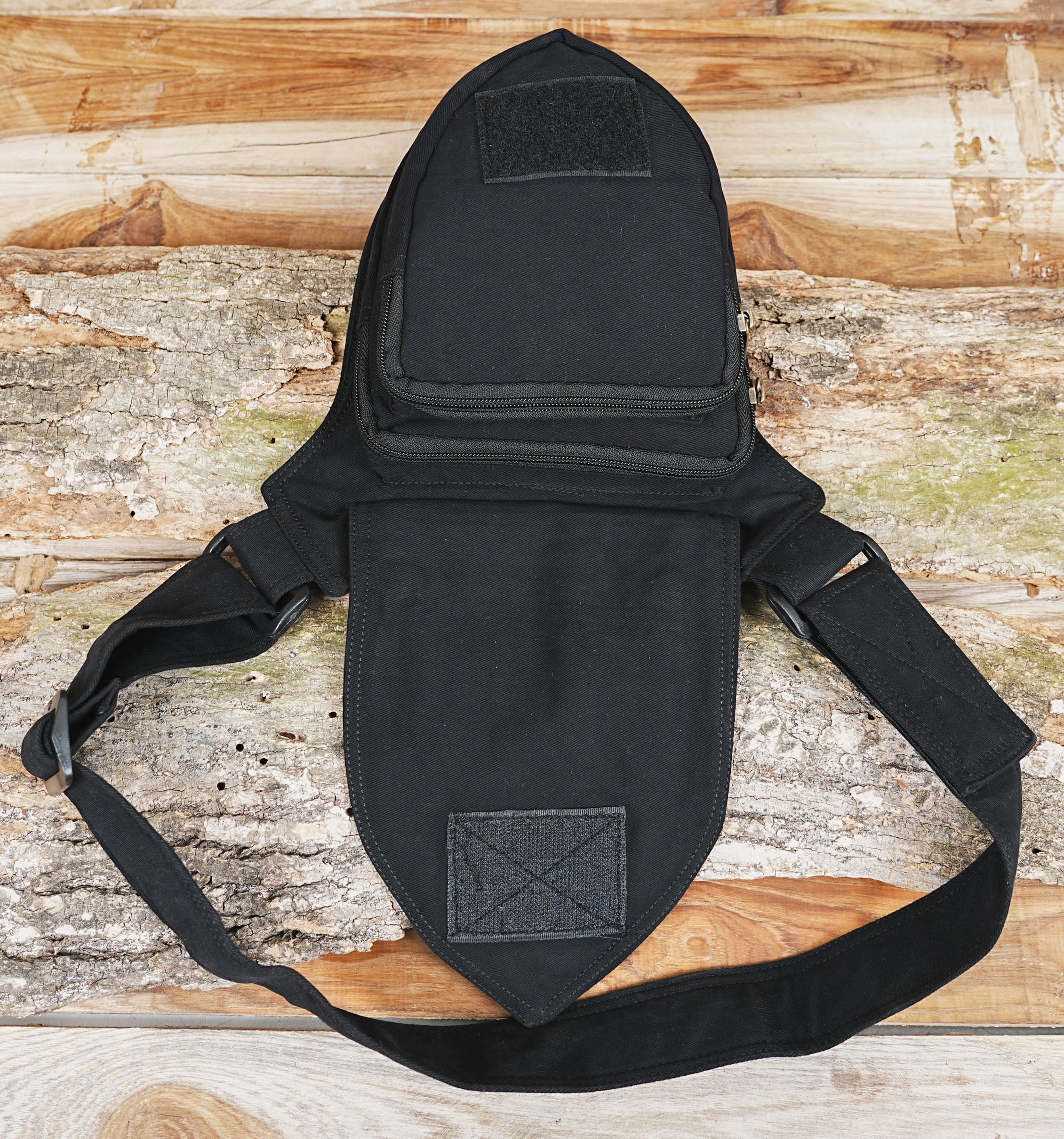 Black hip pouch featuring shield-shaped pocket flap
