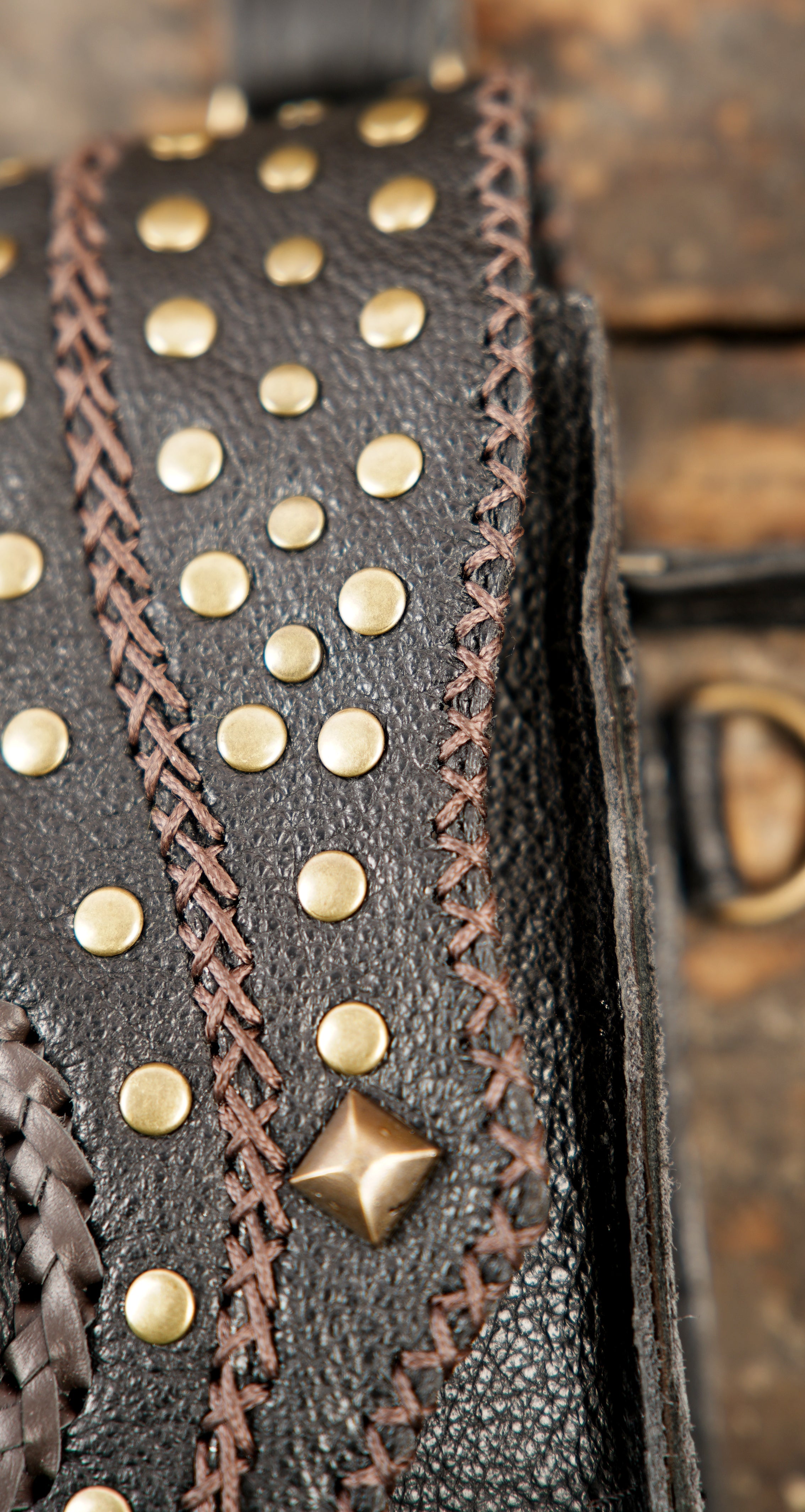 “Handcrafted black leather utility holster with stone-embellished flaps”