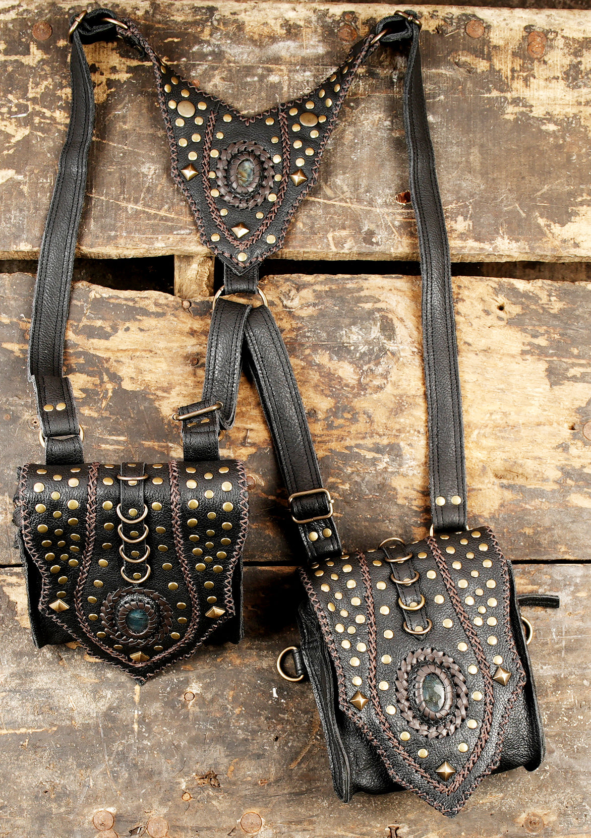 “Decorative black leather holster with hand-stitched edges and metal studs”