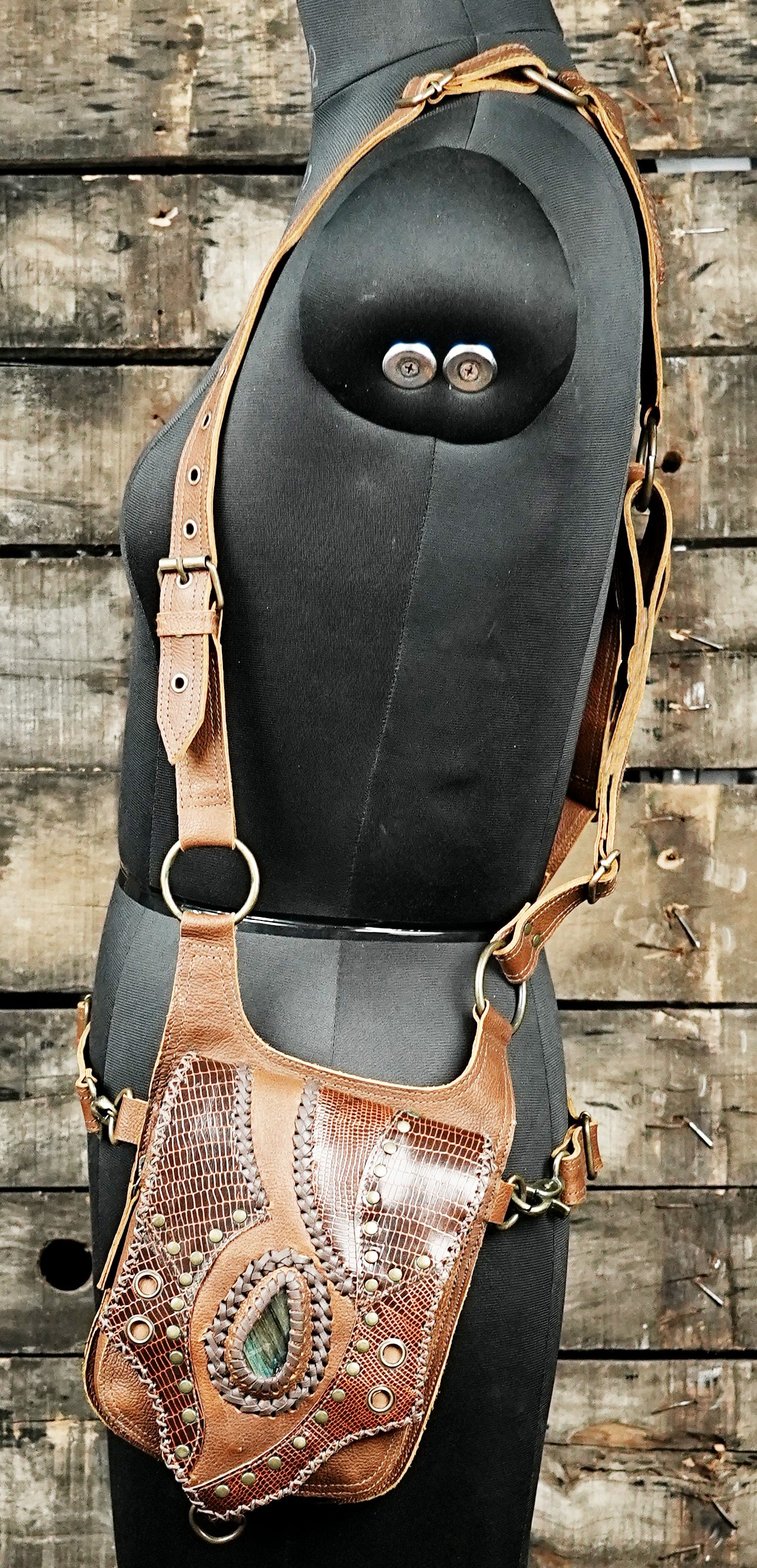 “Brown leather travel holster with embossed reptile pattern and dual pockets”