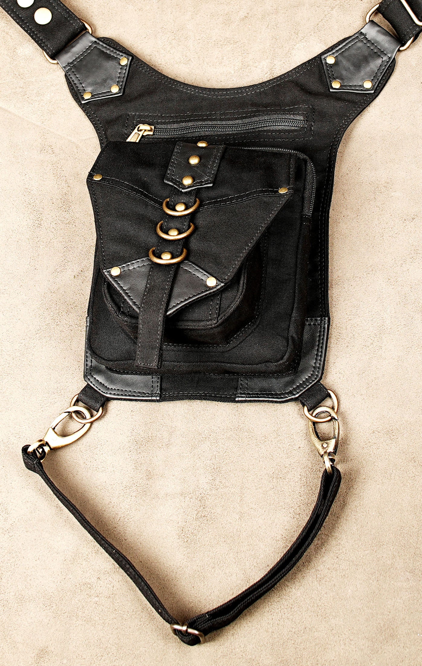 Festival thigh pocket belt with adjustable leg strap and decorative metal rings.