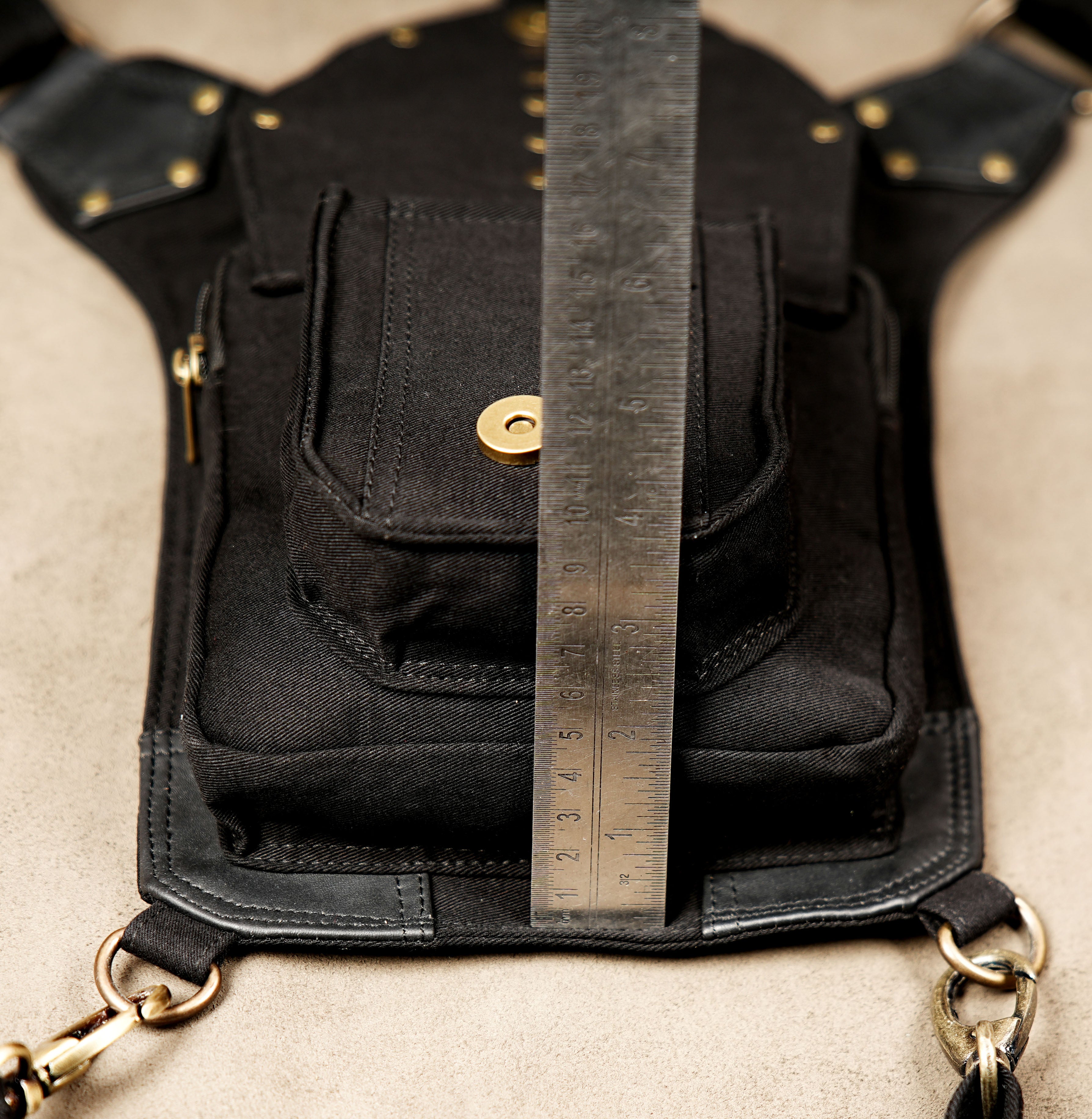 Steampunk motorcycle hip bag with secure zip pockets and studded flap accent.
