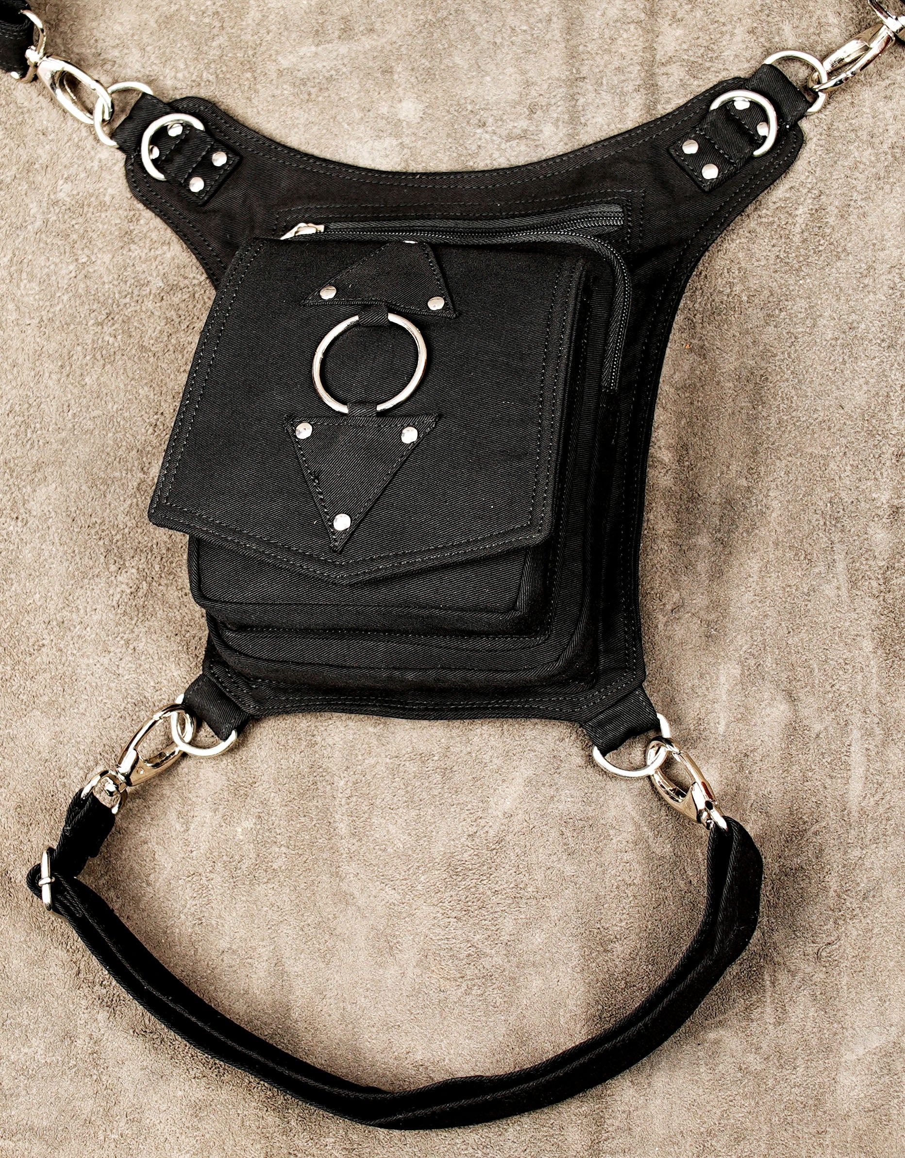 Convertible thigh bag with adjustable straps and front zip pocket