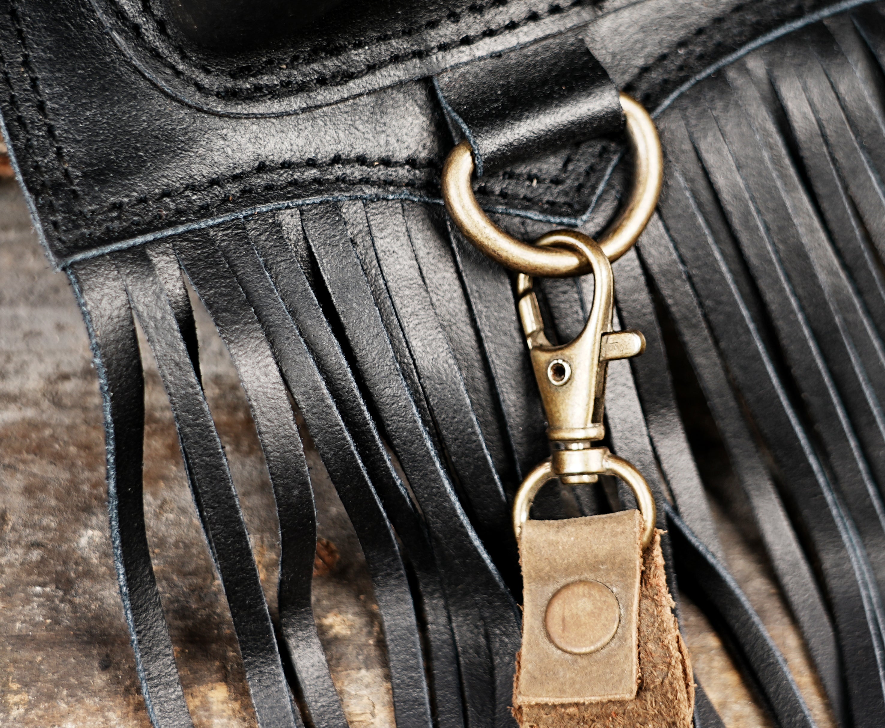 Artisan leather waist belt with snakeskin texture, brass hardware, and fringe