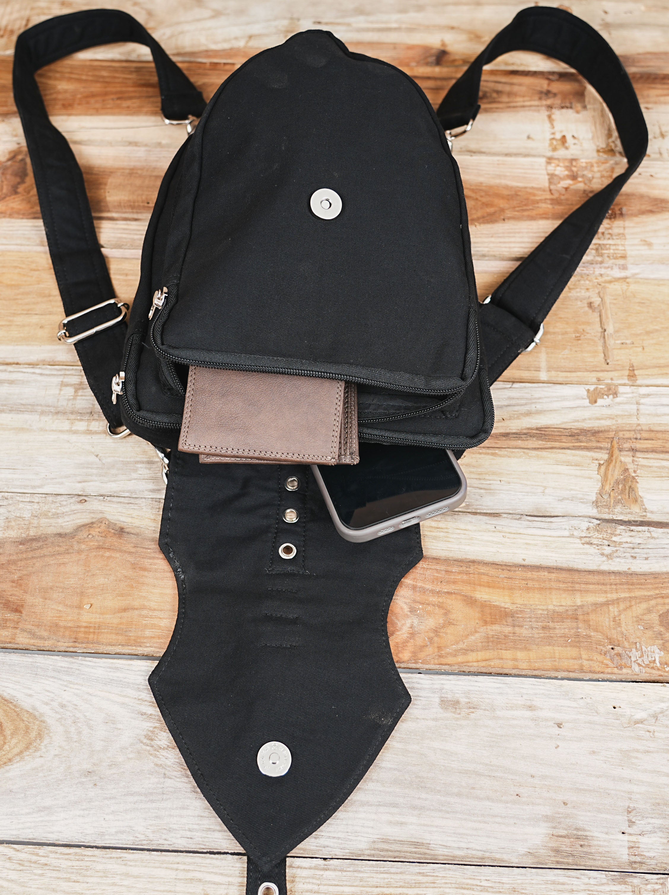 Industrial punk style shoulder pack with secure zippers and a front flap closure